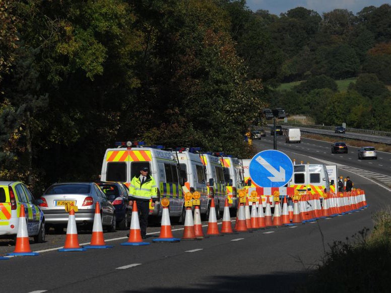 Police officers at the scene on the M5 slip road at junction 14, north of Bristol, where the remains Melanie Hall were discovered in 2009