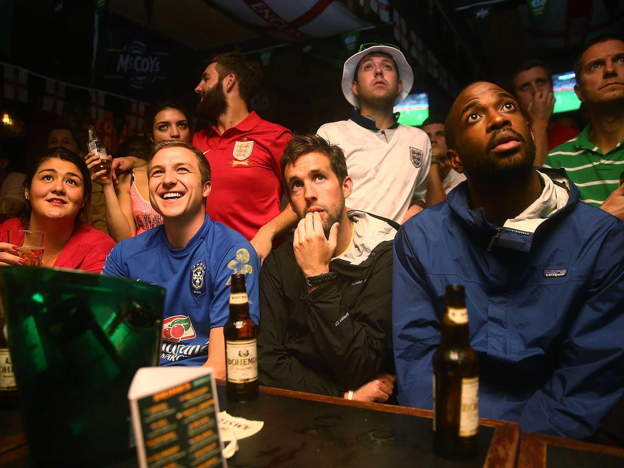 Football fans watch a match during the 2014 World Cup