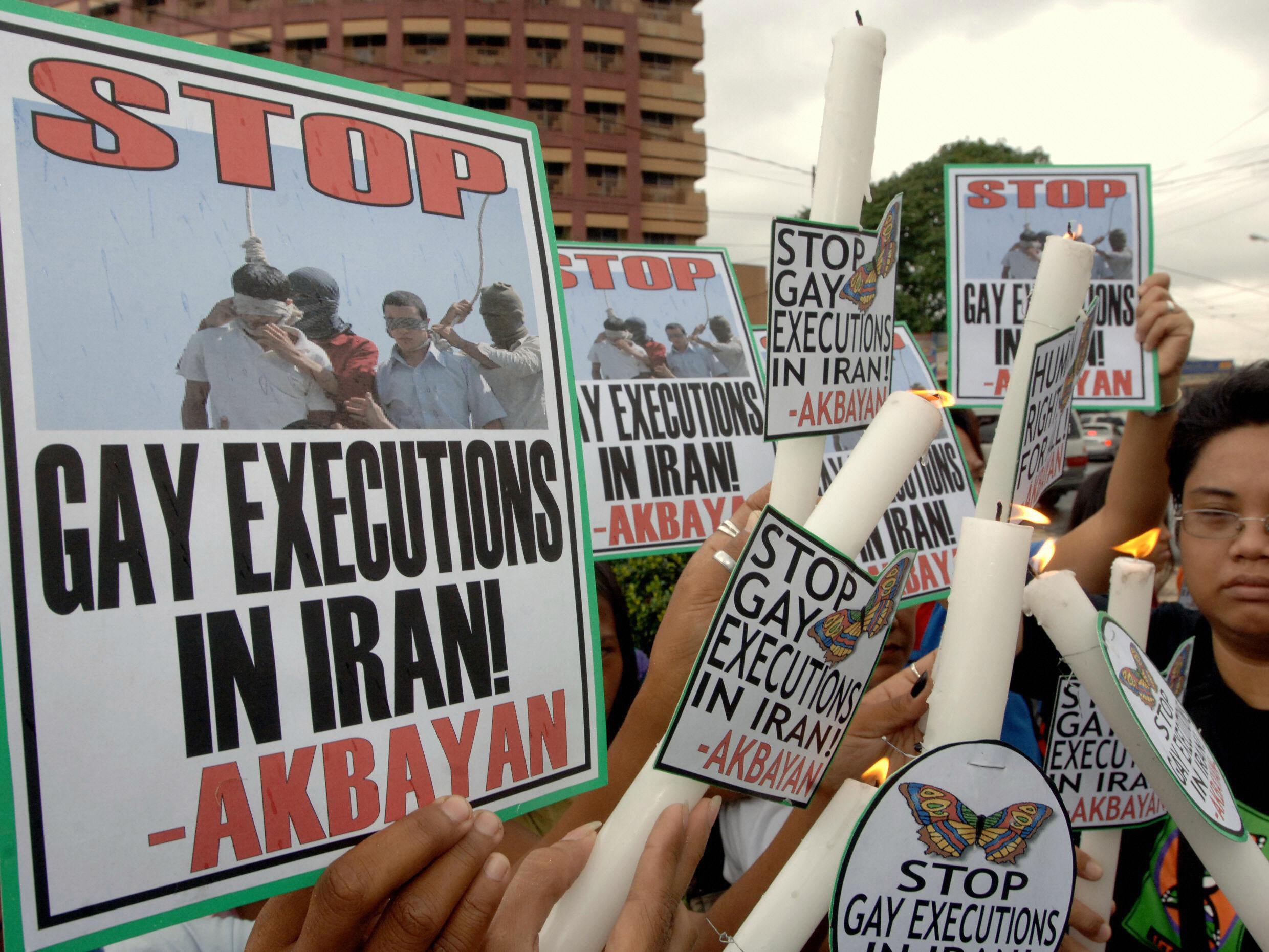 Protesters light candles in Manila, Philippines to condemn the execution of two teenagers in Iran because of their homosexuality