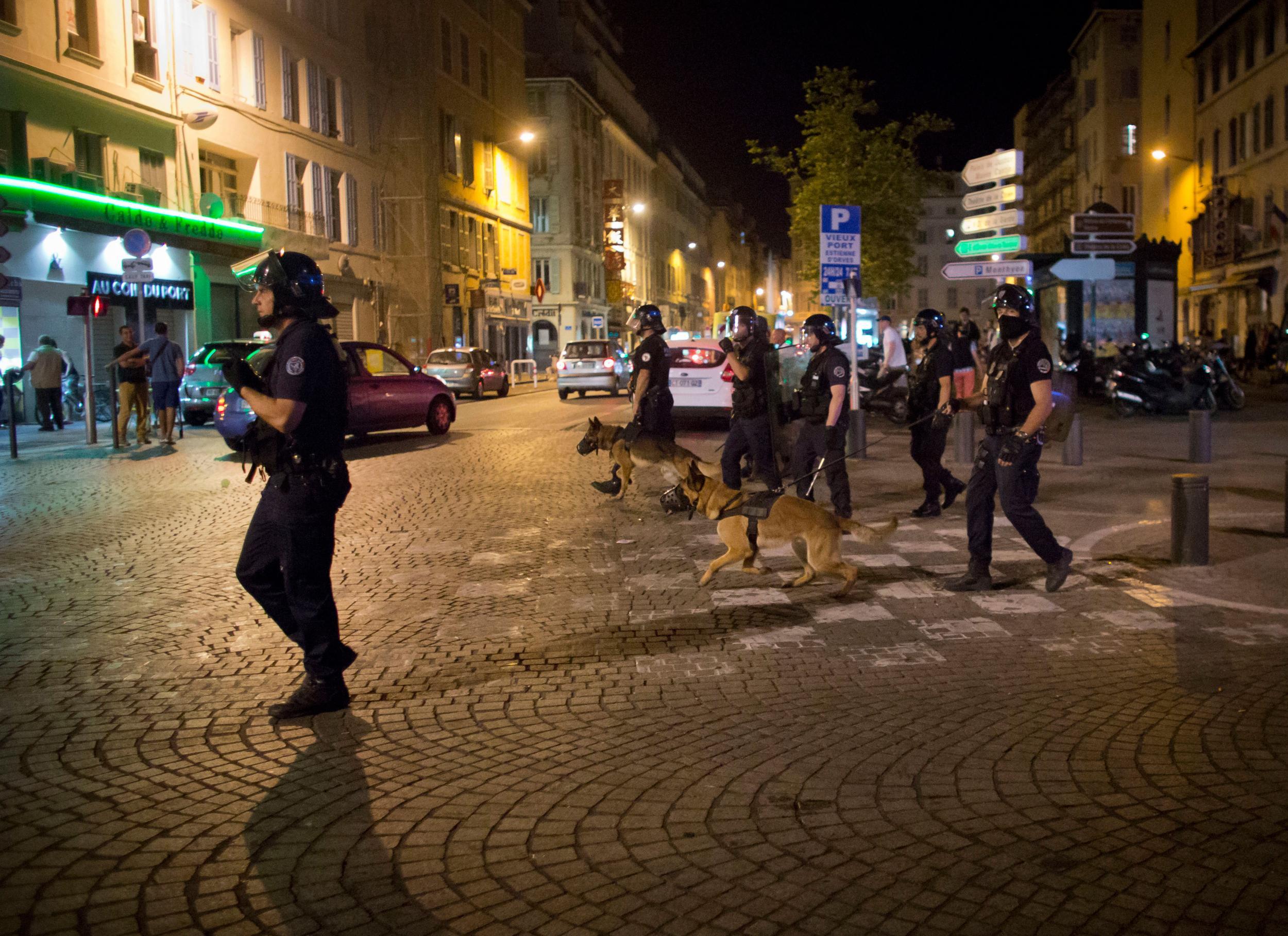 Police patrols on a street following scuffles in Marseille
