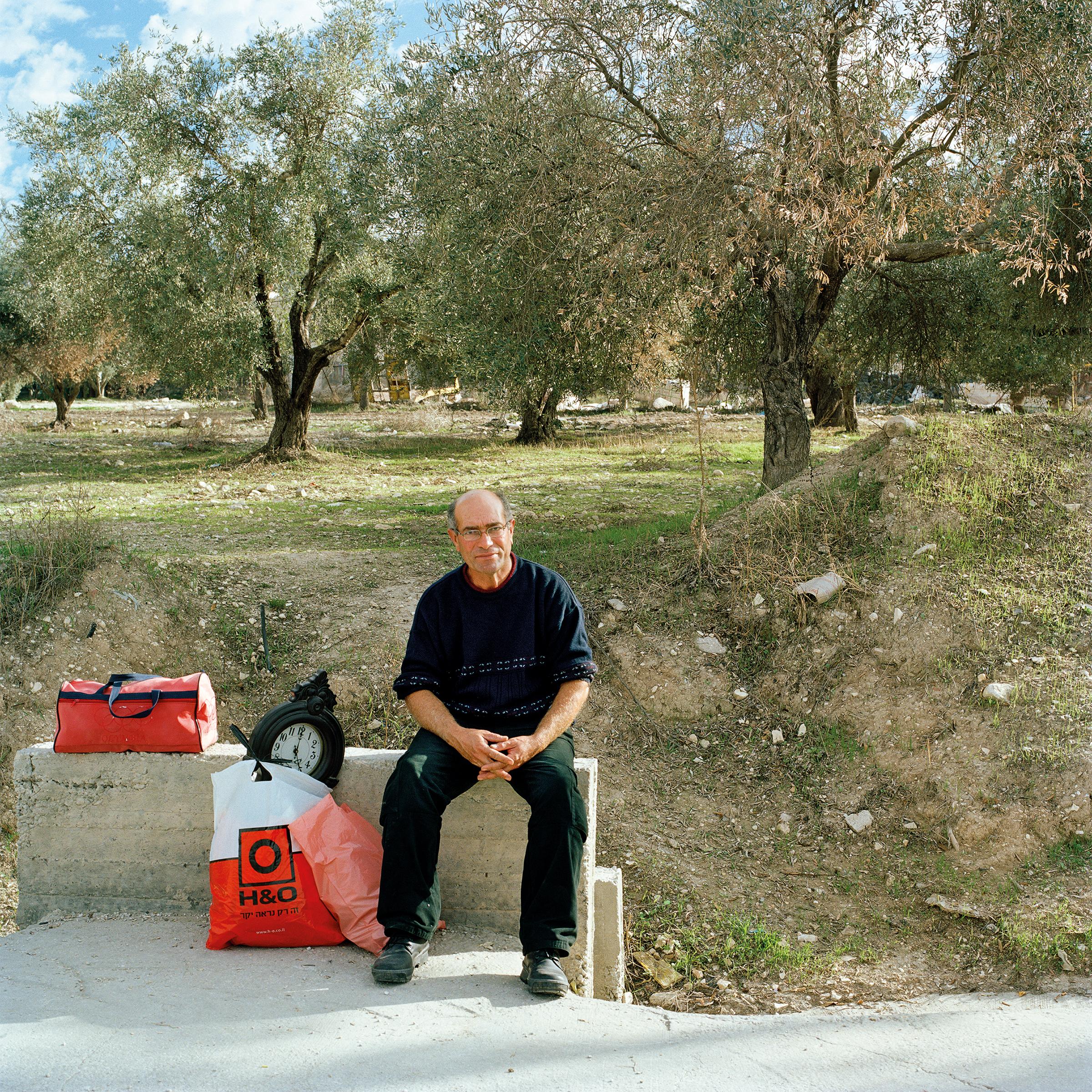 Palestinian waiting at the crossroads of Route 60 and the road to Sanur, Palestine.