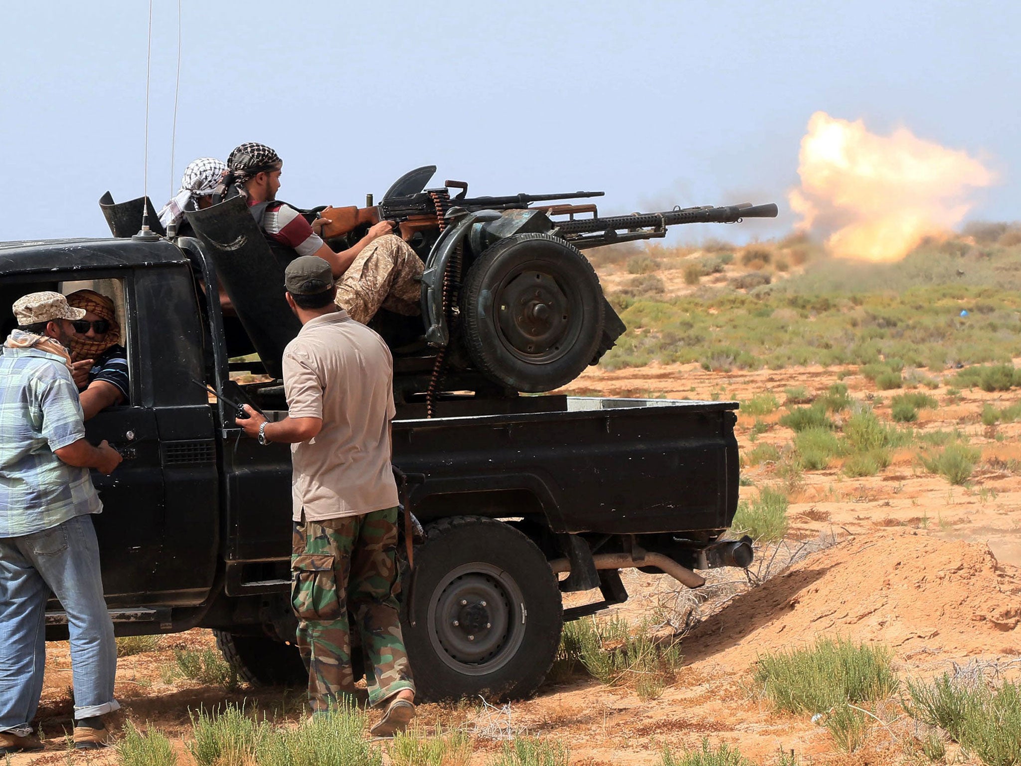 Forces loyal to Libya's UN-backed unity government fire during clashes with Isis around 14 miles west of Sirte on June 2, 2016.