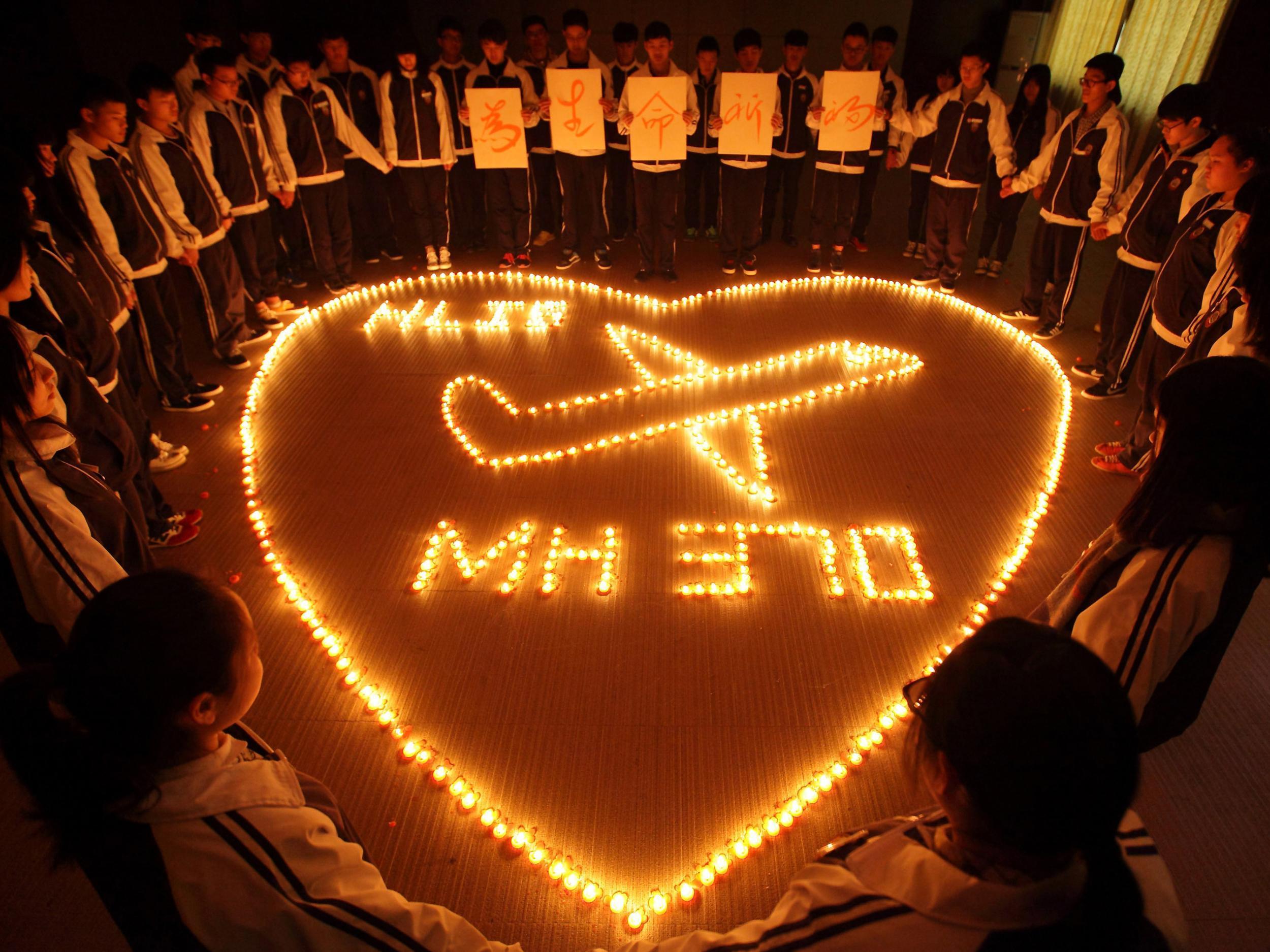 Students at Hailiang International School light candles for the passengers on missing Malaysia Airlines flight MH370 (Getty Images)