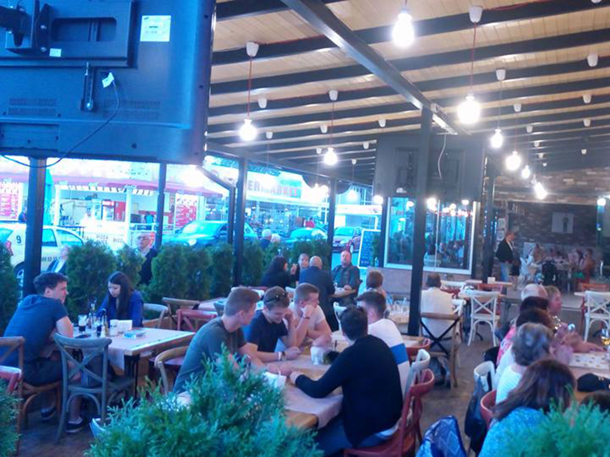 The teenagers, seen around a table in the centre of the image, were photographed by staff at the 4 You restaurant shortly before the shooting on 8 June