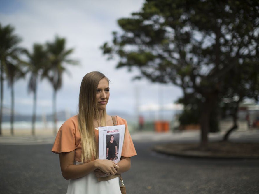 Bonnie Cuthbert, of Australia, holds a photo of her missing boyfriend Rye Hunt, 25,