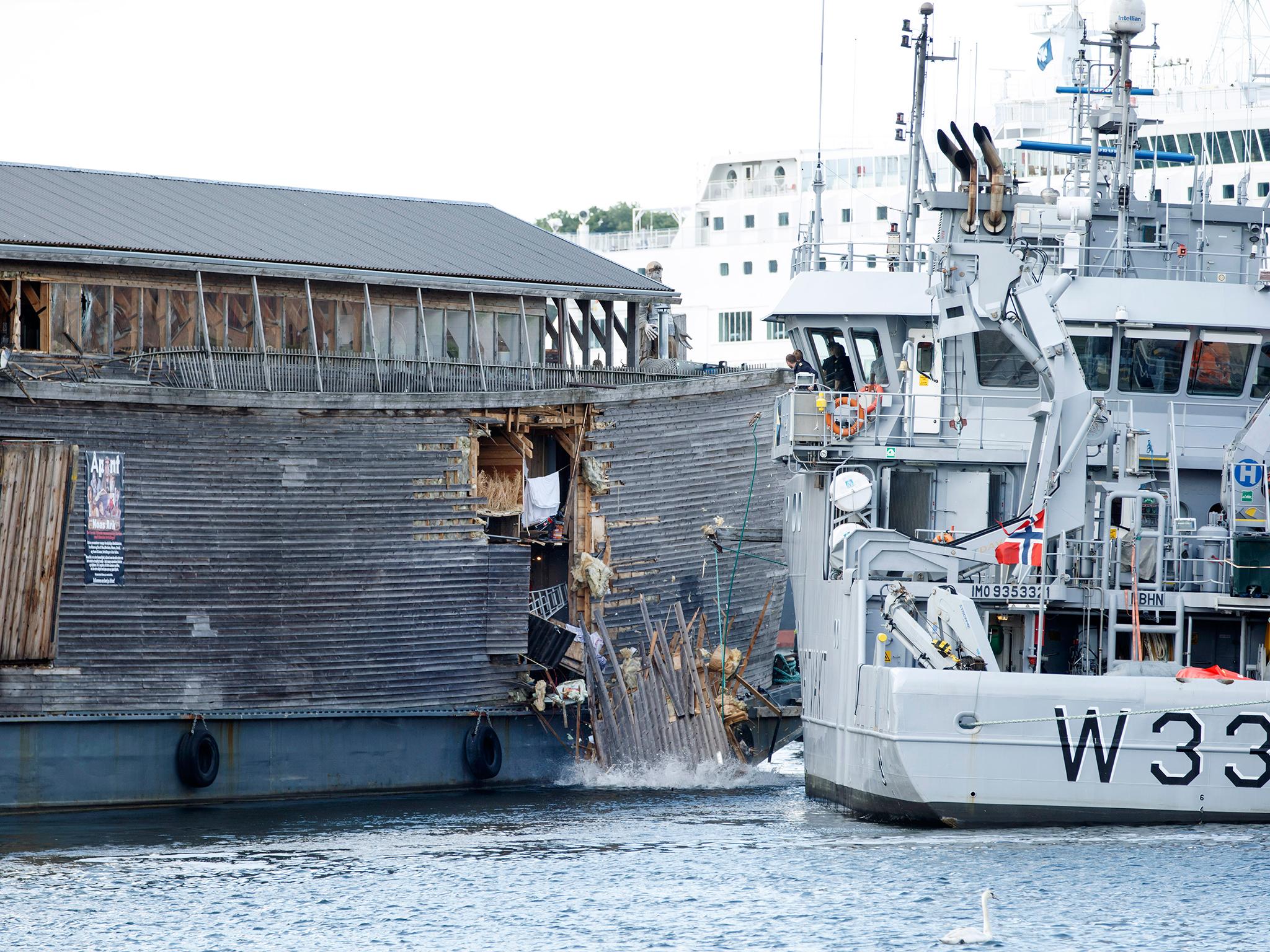 The damage of the hull of a wooden ship built to represent Noah's Ark after it crashed into a moored Coast Guard vessel