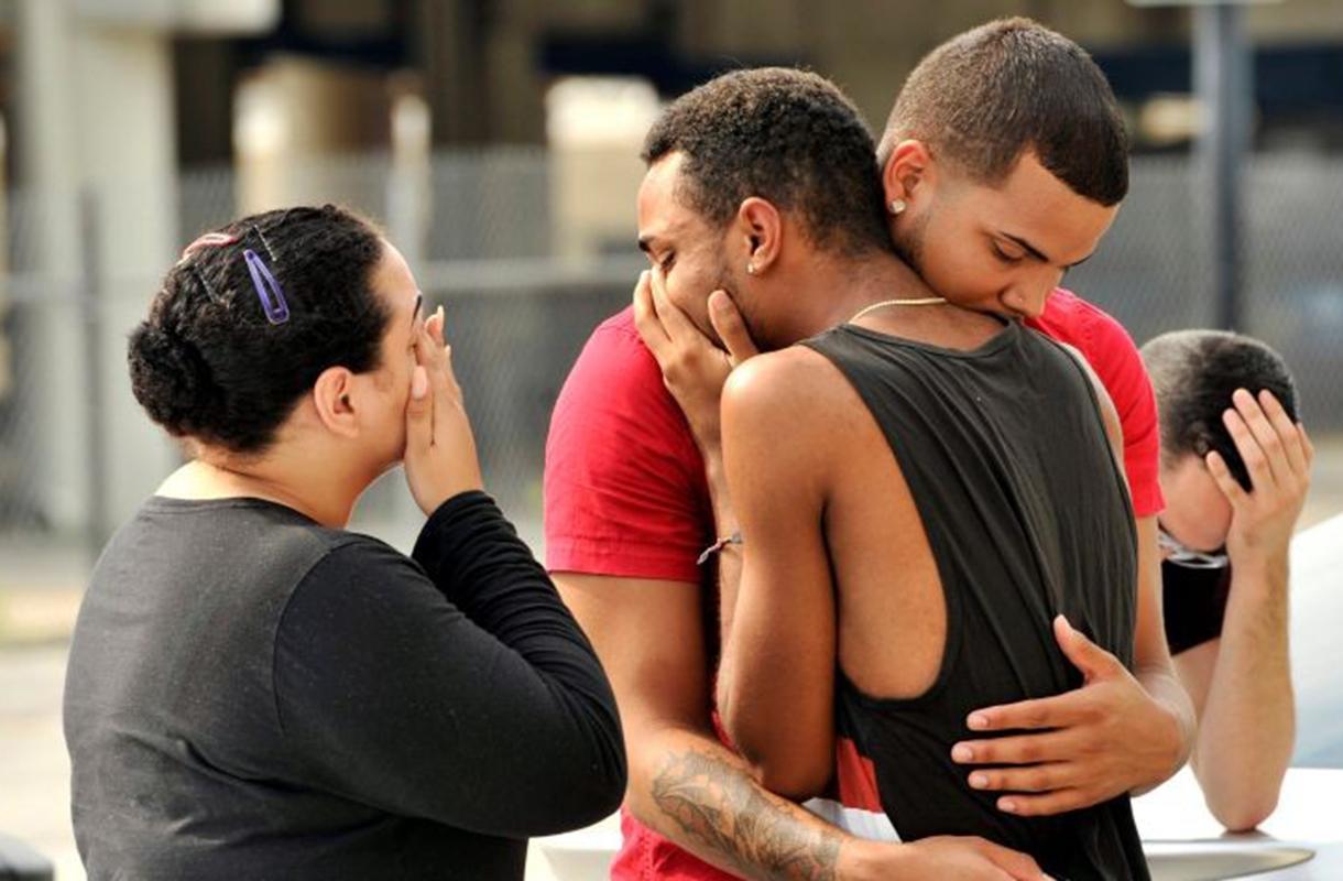 Friends and family console one another outside the Orlando Police Headquarters