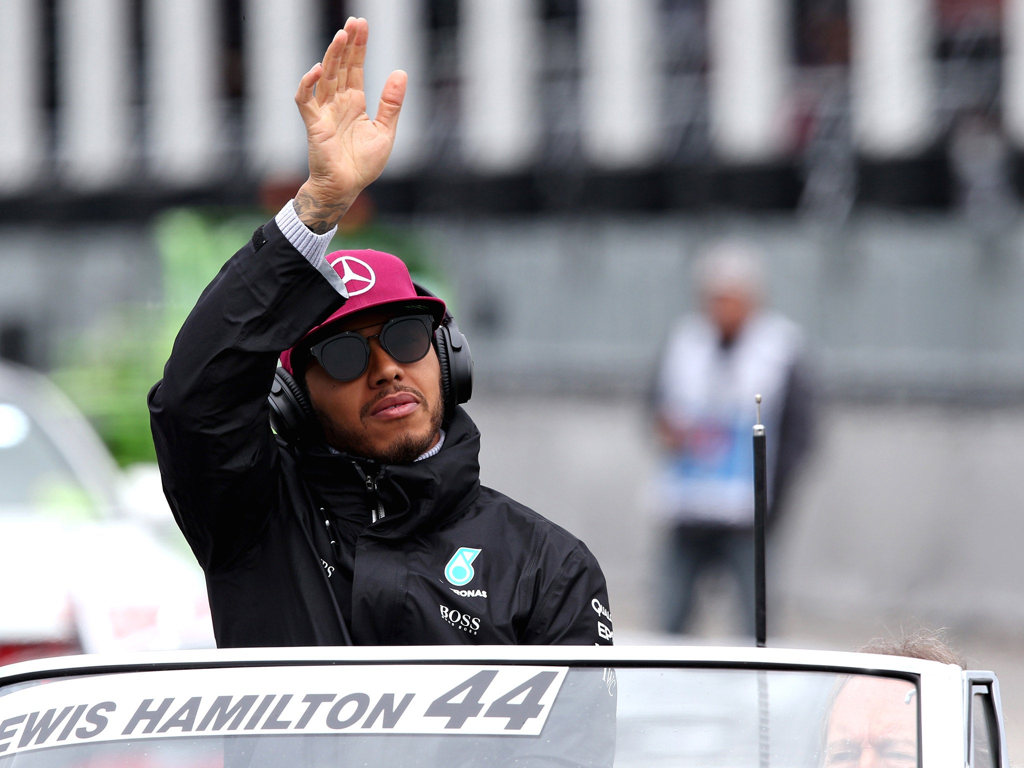 Lewis Hamilton waves to the crowd during the drivers' track parade