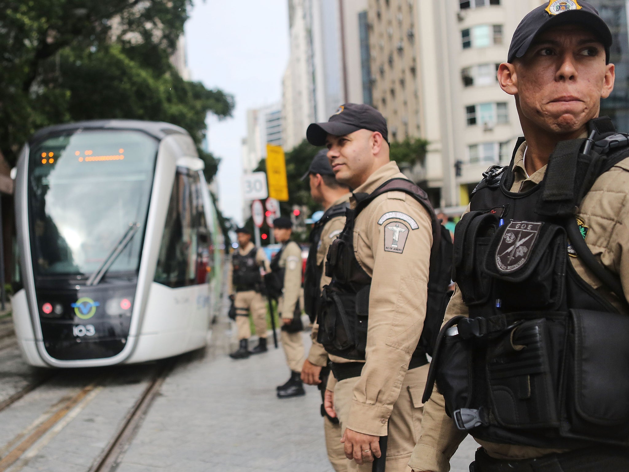 Rio police on patrol ahead of the Olympics near the city's new tram system