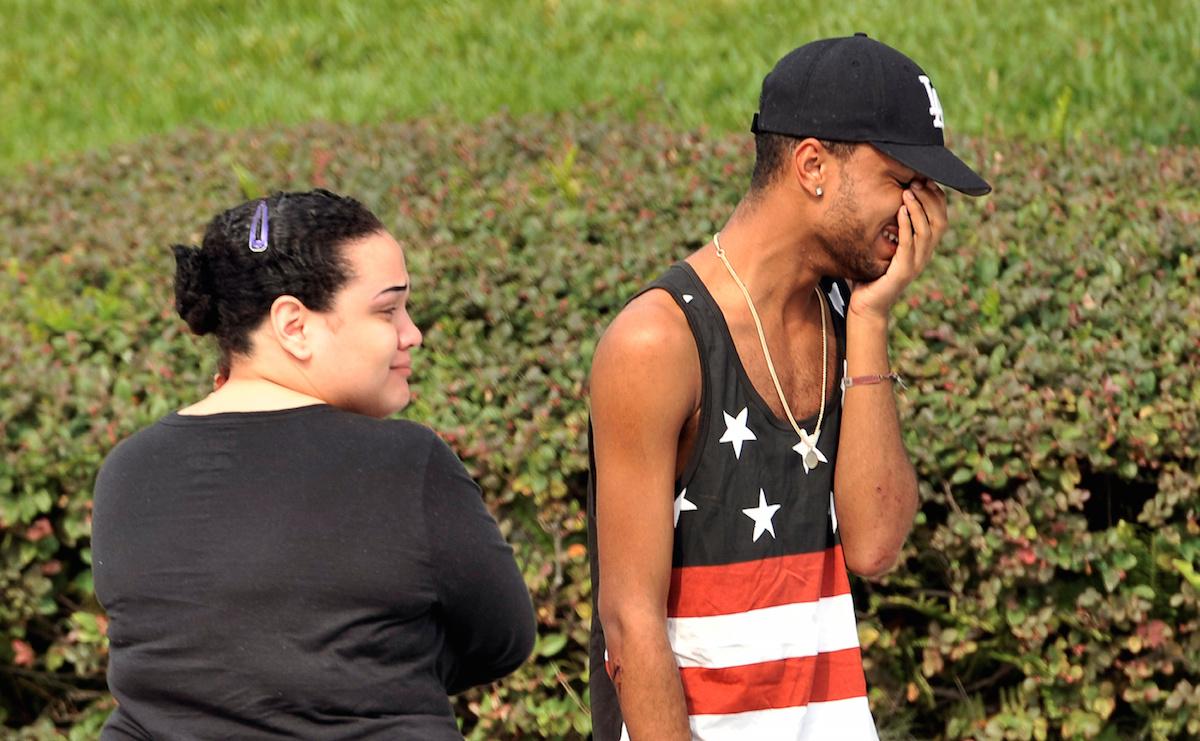 People mourn victims outside the police department in Orlando.