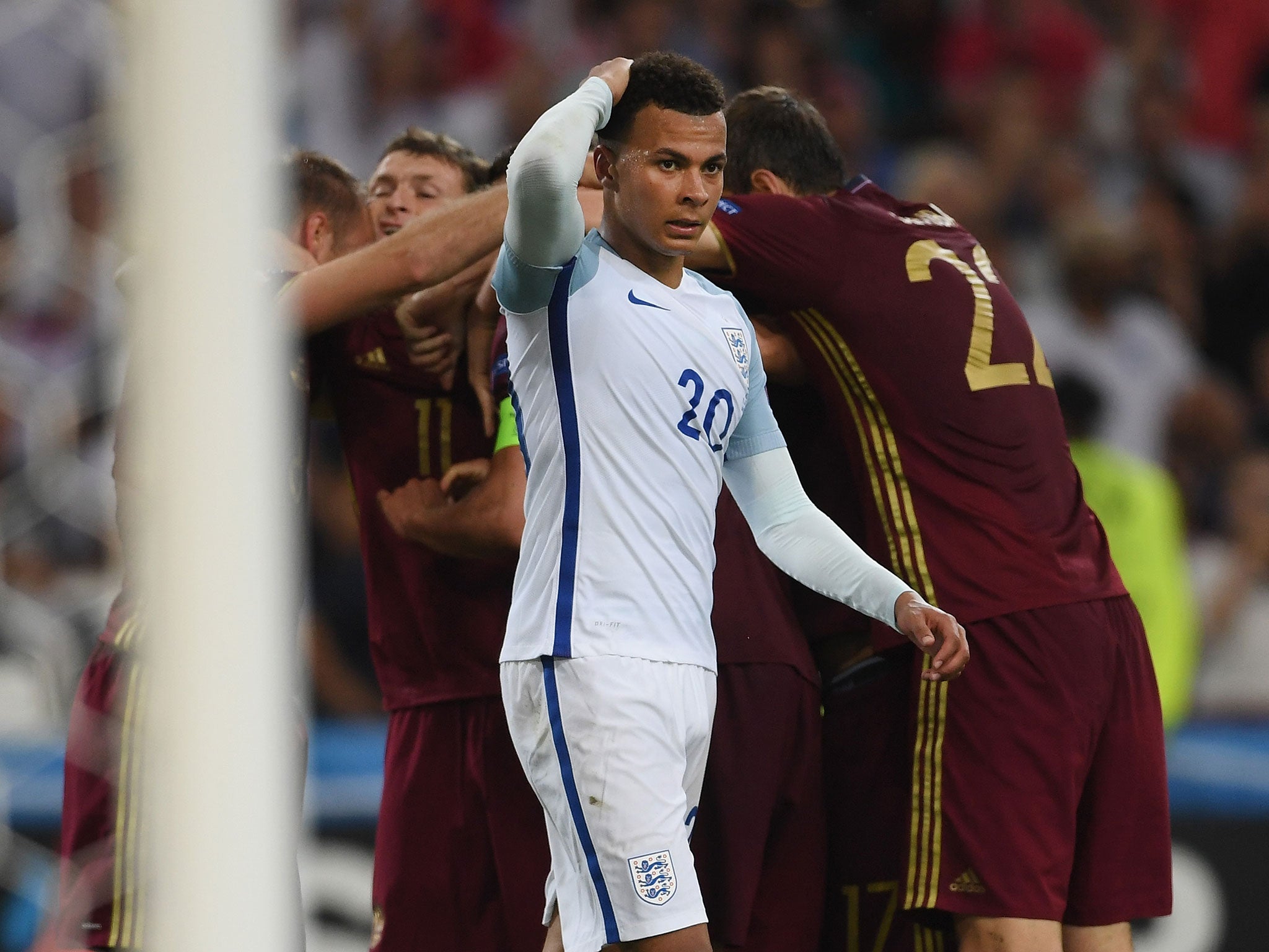 Dele Alli reacts after Russia's late equaliser