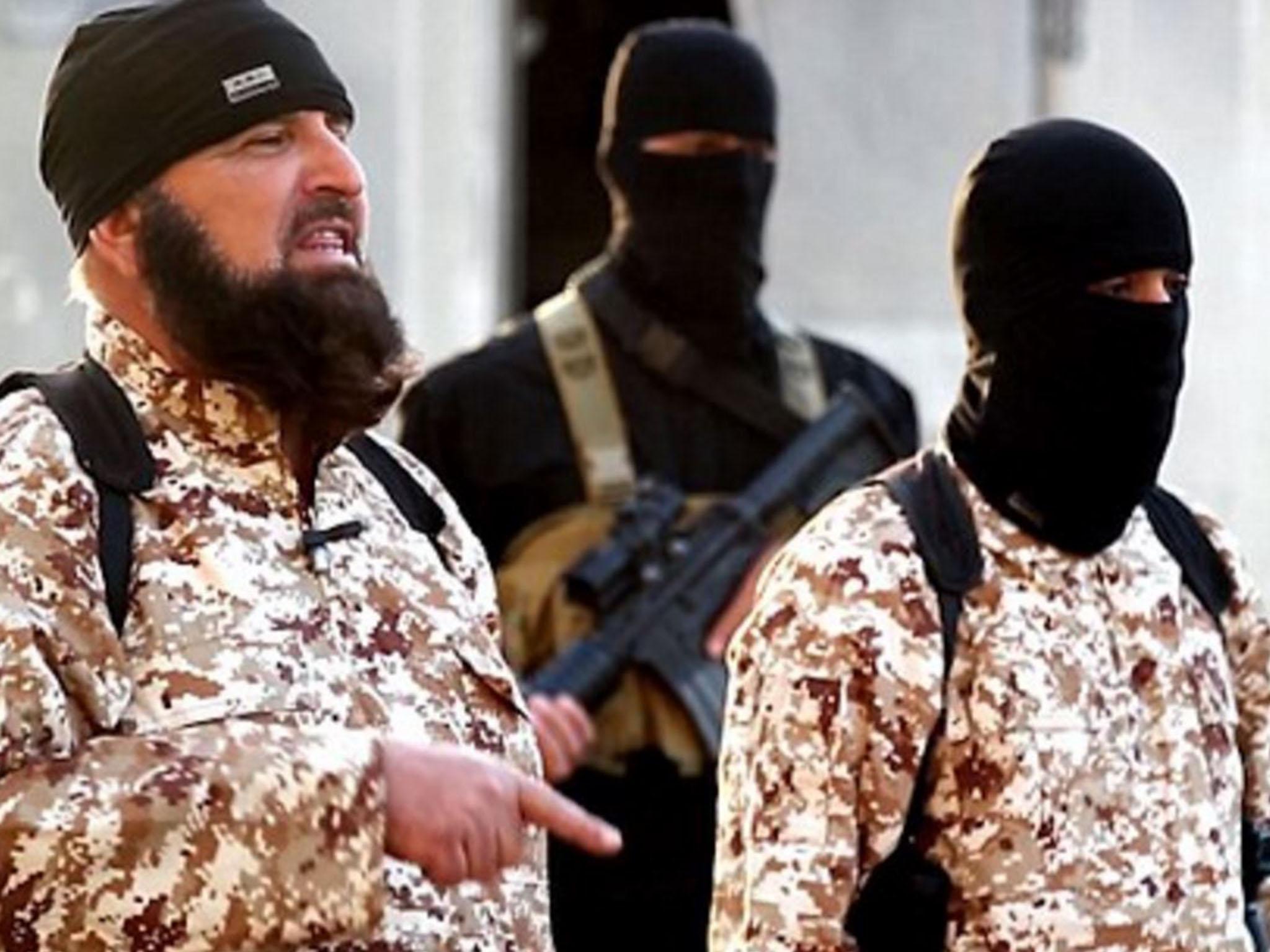 Abu Abdullah (left) stands over the man he claims is his brother, before the execution