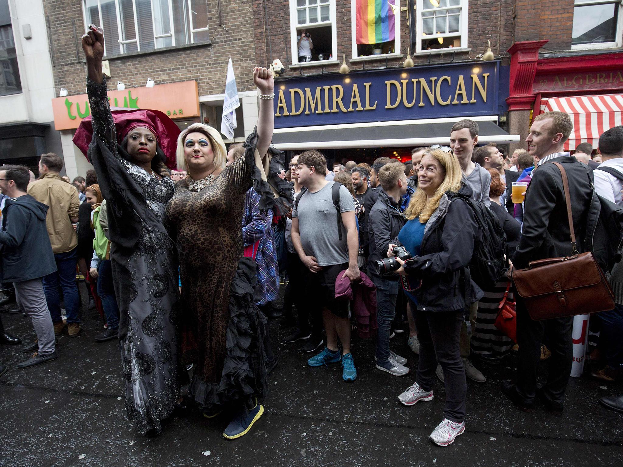 People gather outside the Admiral Duncan pub in Old Compton Street in the Soho district of London for a vigil in commemoration and solidarity with the victims of the Orlando massacre yesterday