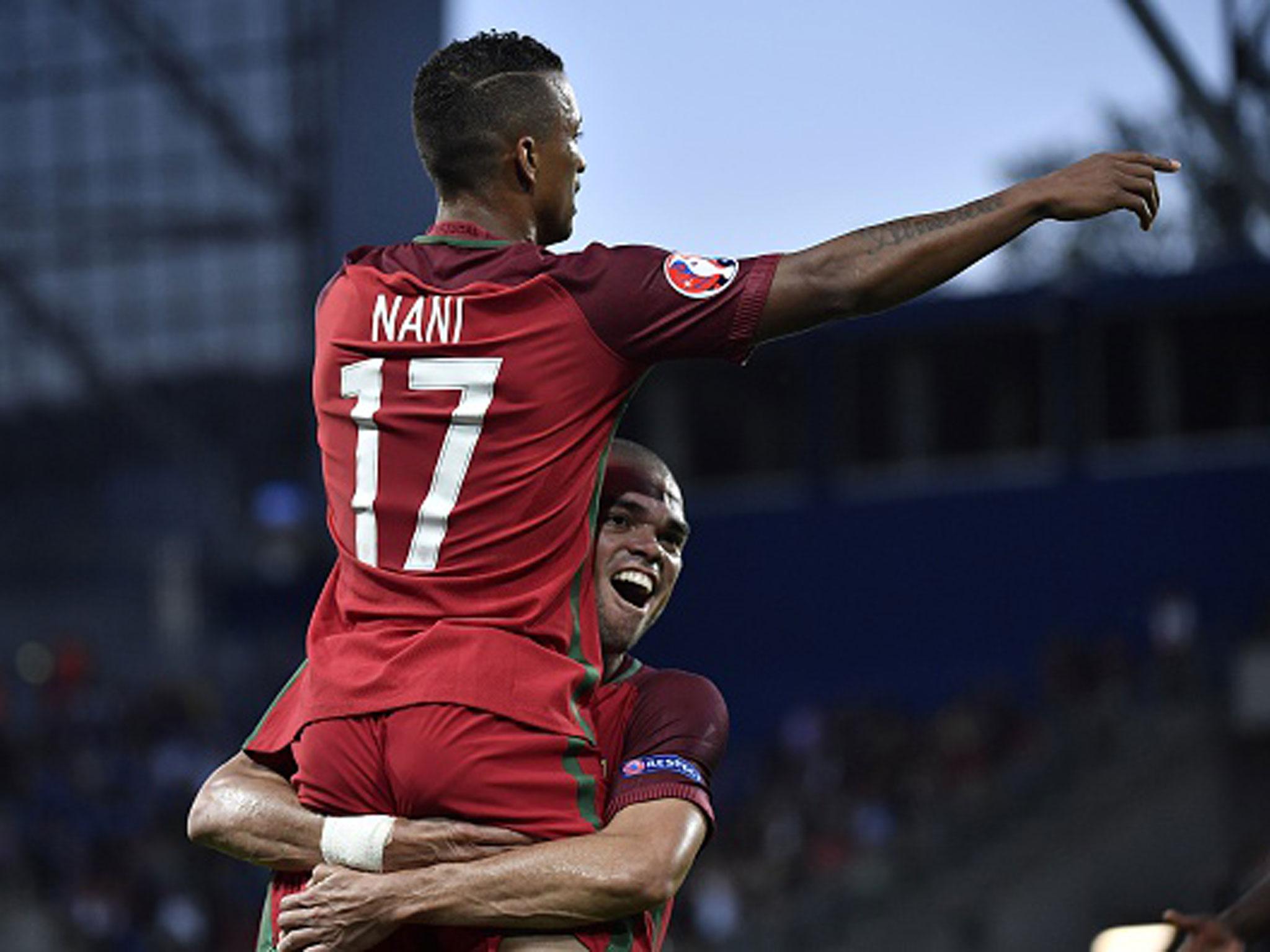 Pepe holds aloft colleague Nani after the midfielder opened the scoring against Iceland from close range (Getty)