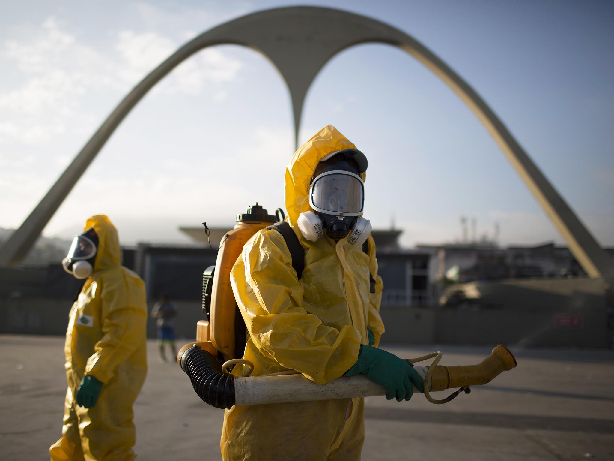 A health worker sprays insecticide at The Sambadrome in Rio, where the archery competition will take place