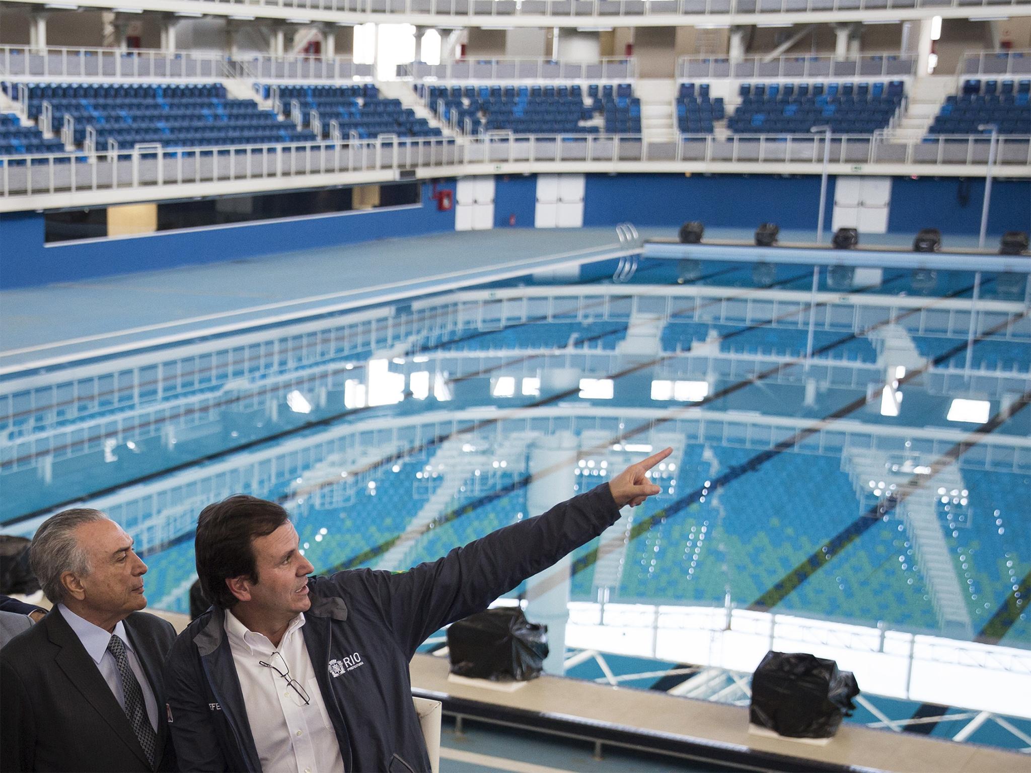 Interim president Michel Temer (left) and Rio Mayor Eduardo Paes visit the Olympic Aquatics