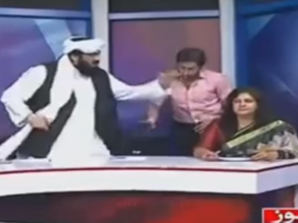 Pakistani senator Hafiz Hamdullah (left) gesticulates during a heated panel show debate about honour killings