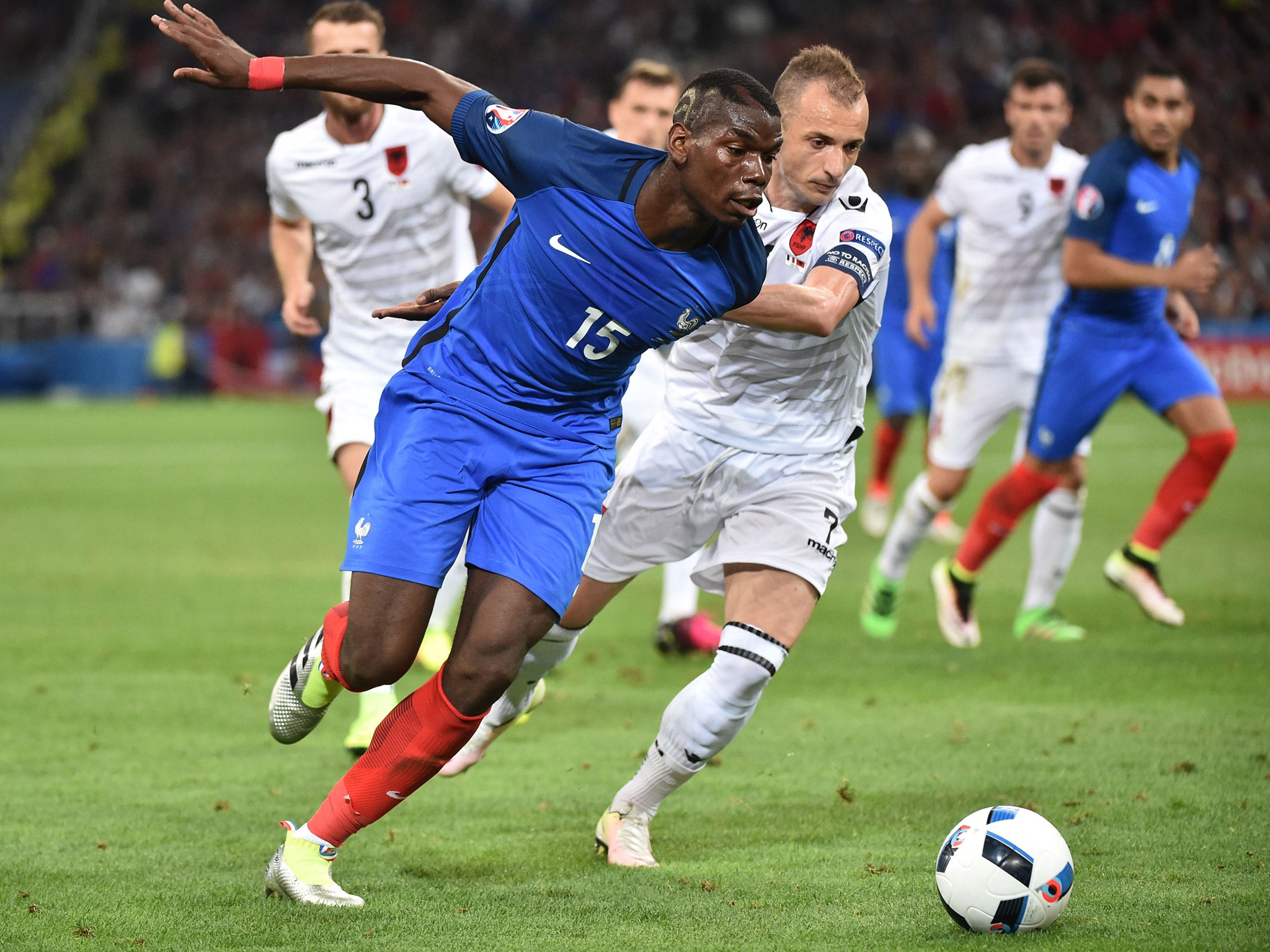 Paul Pogba races for the ball against Albania