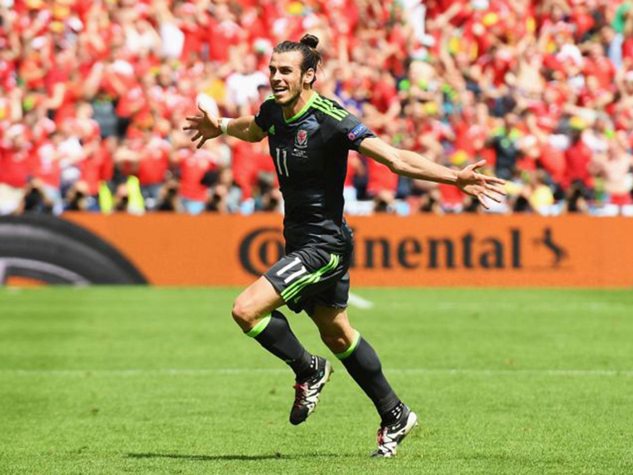 Gareth Bale celebrates after scoring the first goal in the match against England