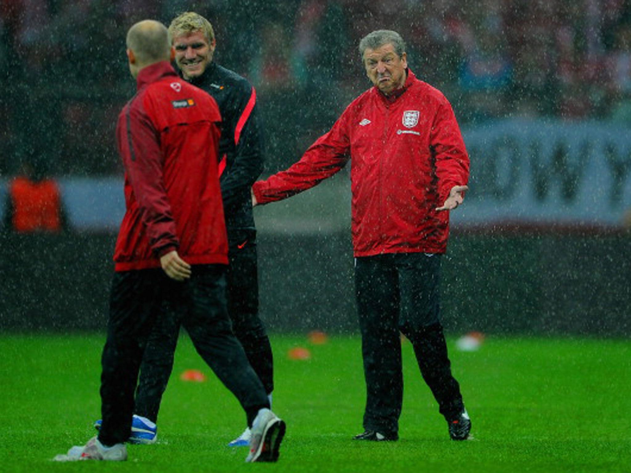 Roy Hodgson inspects the sodden playing surface in Warsaw four years ago (Getty)