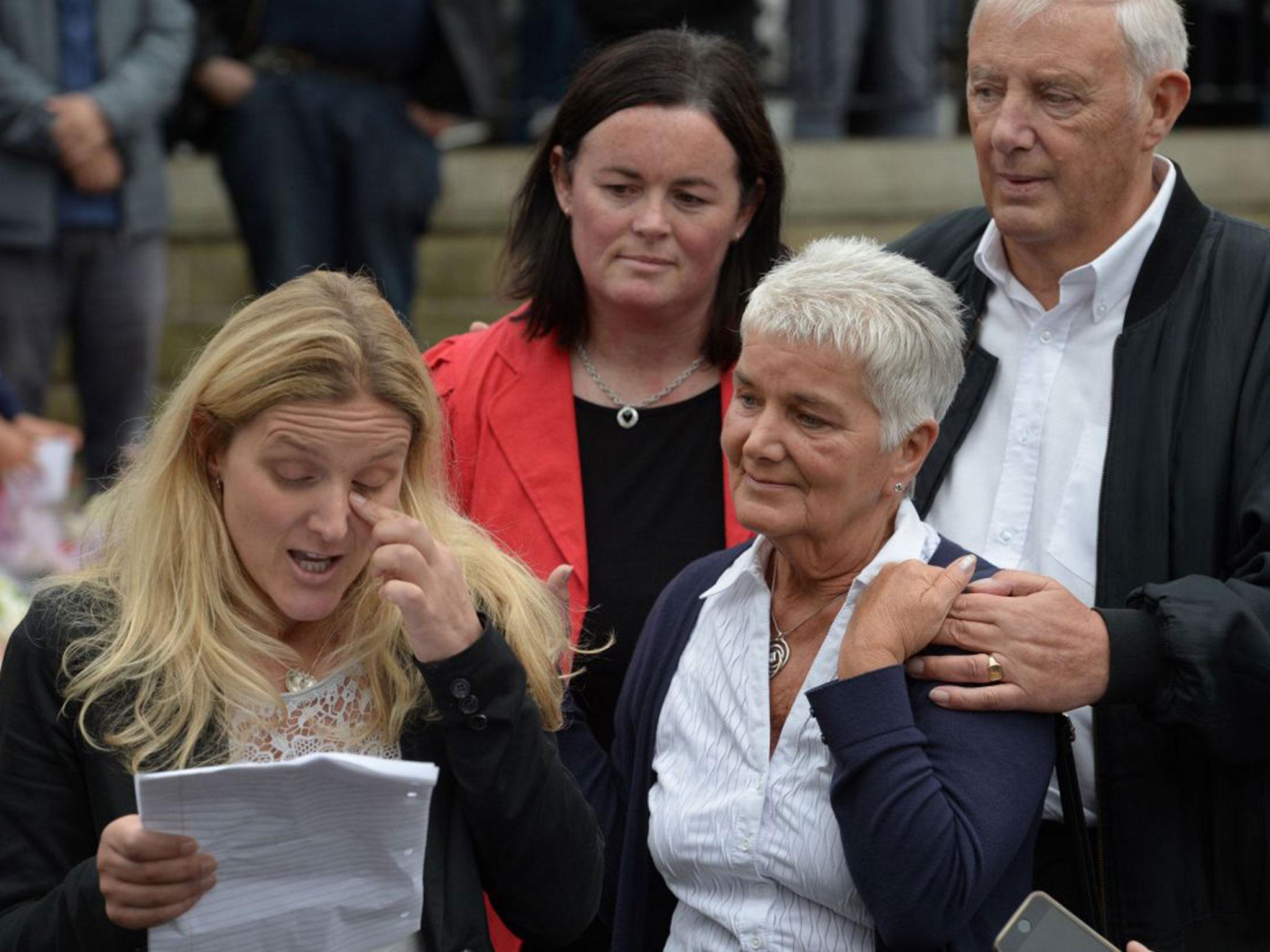 Kim Leadbeater (L), the sister of murdered Labour MP Jo Cox, is joined by her parents Jean (2nd R) and Gordon Leadbeater (R) as she reads a tribute to Jo near to the location where she was killed, in Birstall, Yorks