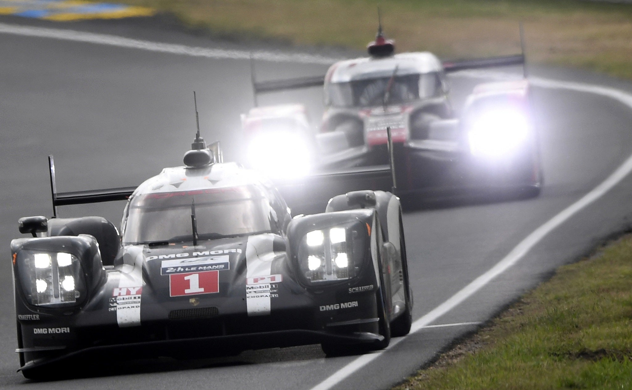 The No 1 Porsche of Brendon Hartley leads the No 7 Audi