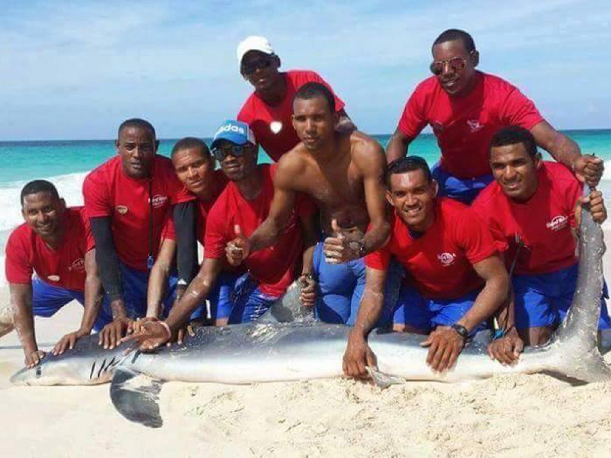 A video shows a group of men pulling it onto the beach with ropes