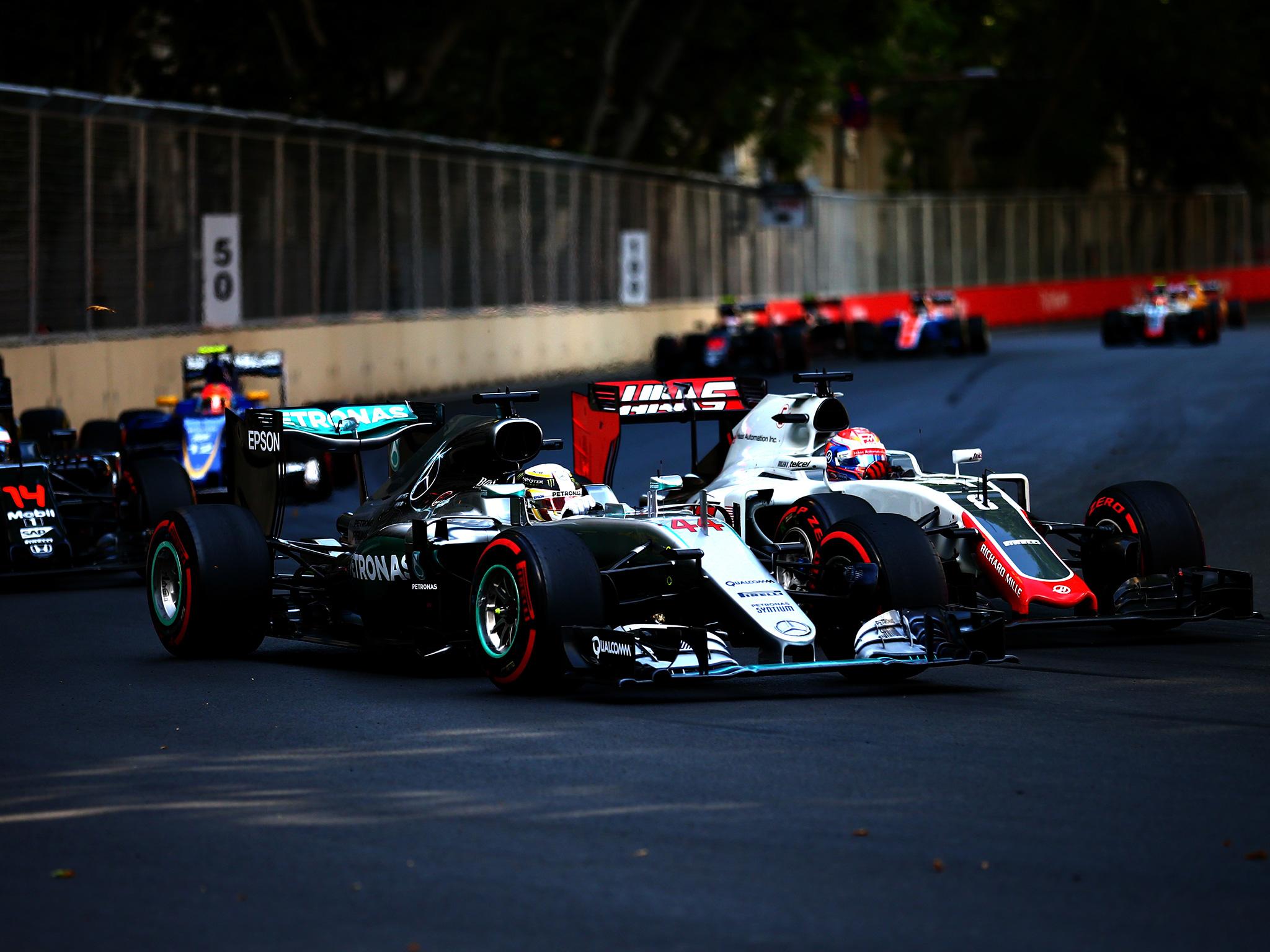 Lewis Hamilton battles with Romain Grosjean on the track in Baku