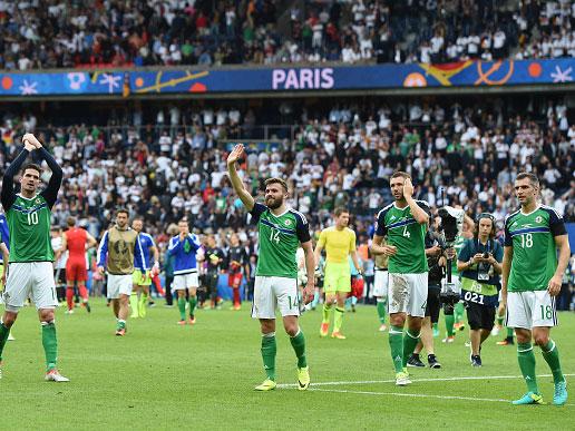 Northern Ireland players salute the travelling Green Army at the final whistle (Getty)