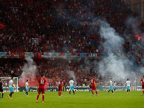 &#13;
Turkish supporters lit flares in celebration, which found their way onto the pitch (Getty)&#13;