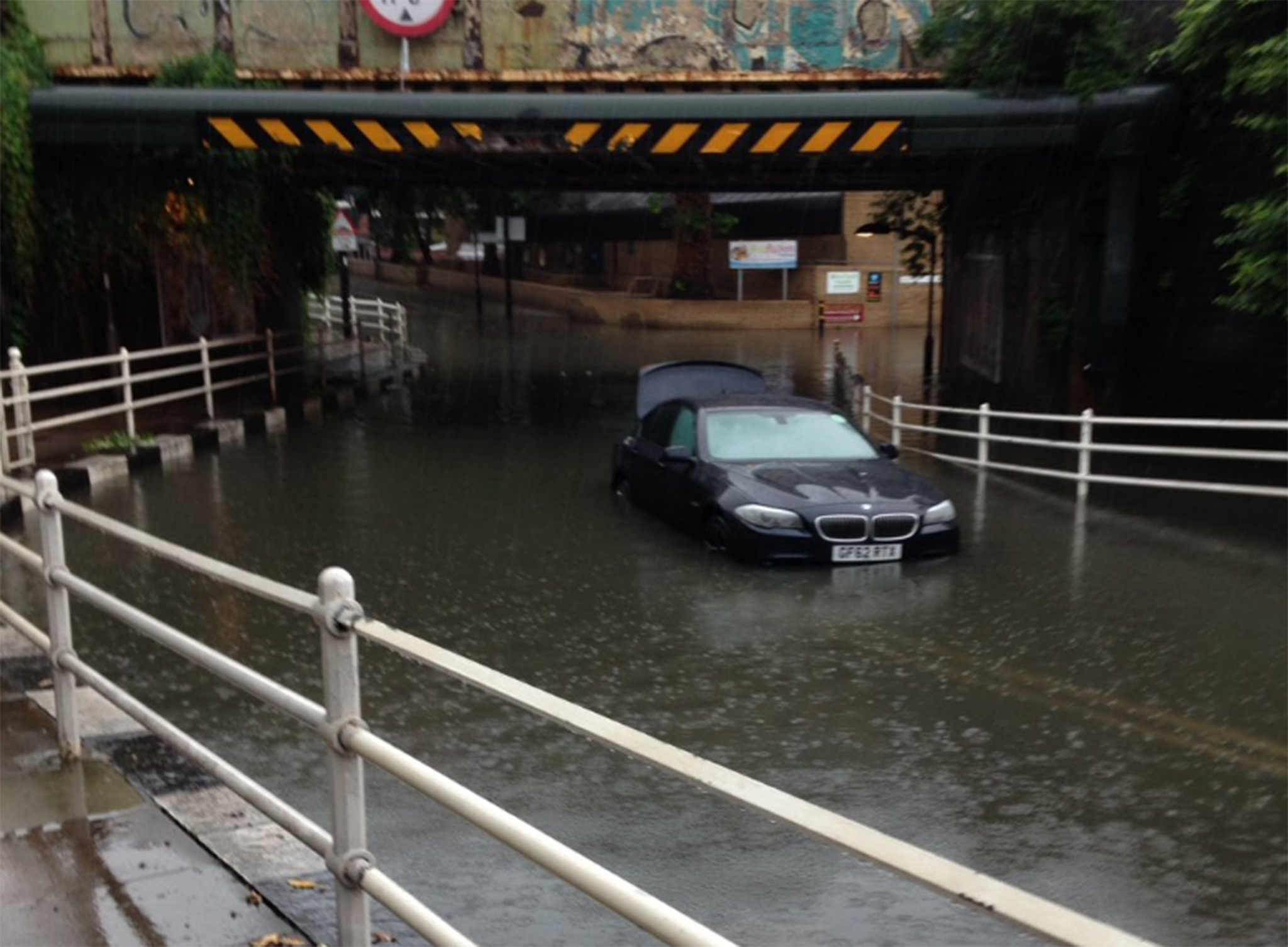 A car stuck under a railway bridge on Latchmere Road in Battersea, London