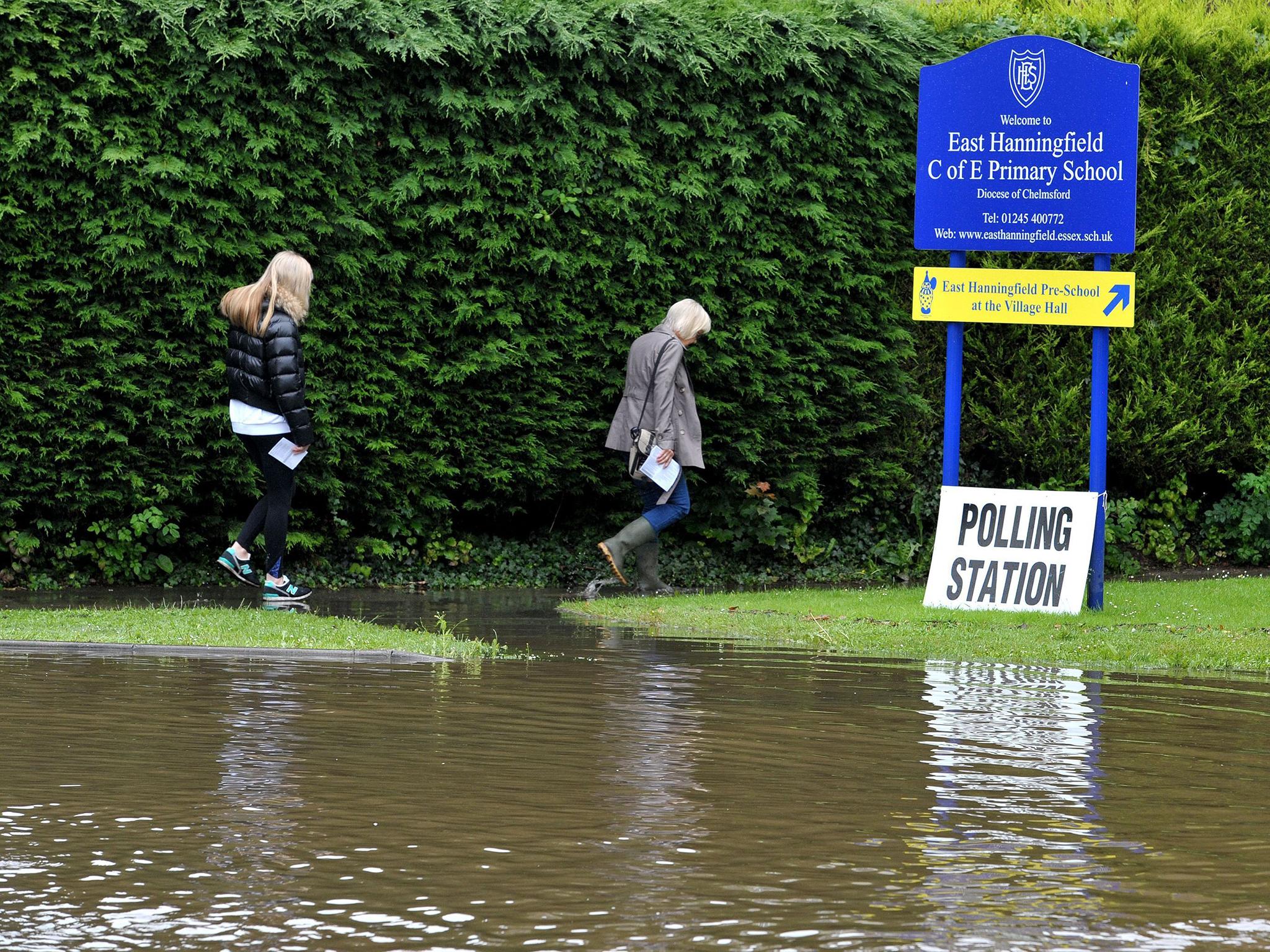 Voters make their way through flooding to a polling station in East Hanningfield, Essex