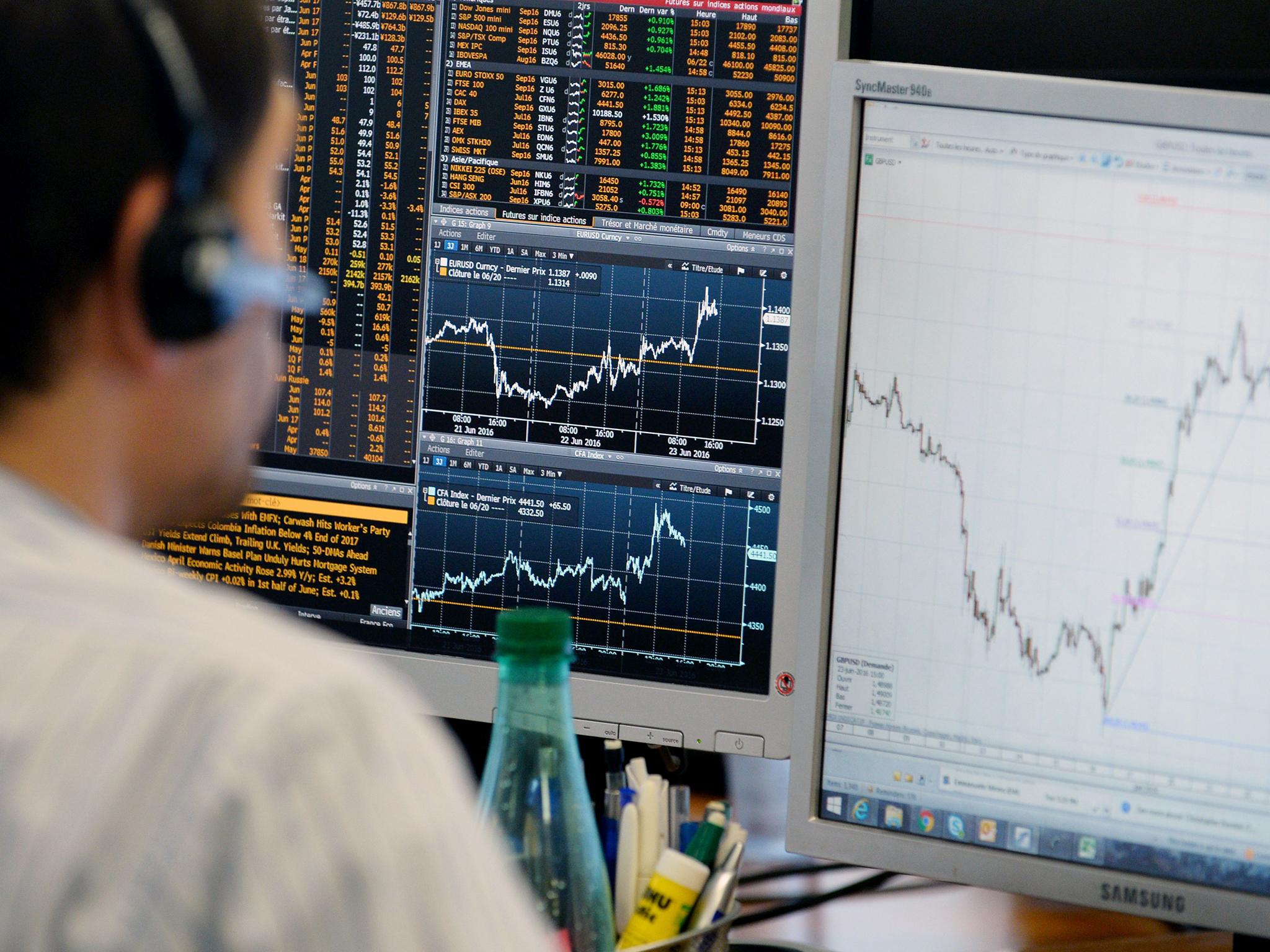 A trader checks his screens at investment bank Saxo Banque in Paris, as European stocks rallied and the pound hit its highest level during the referendum campaign