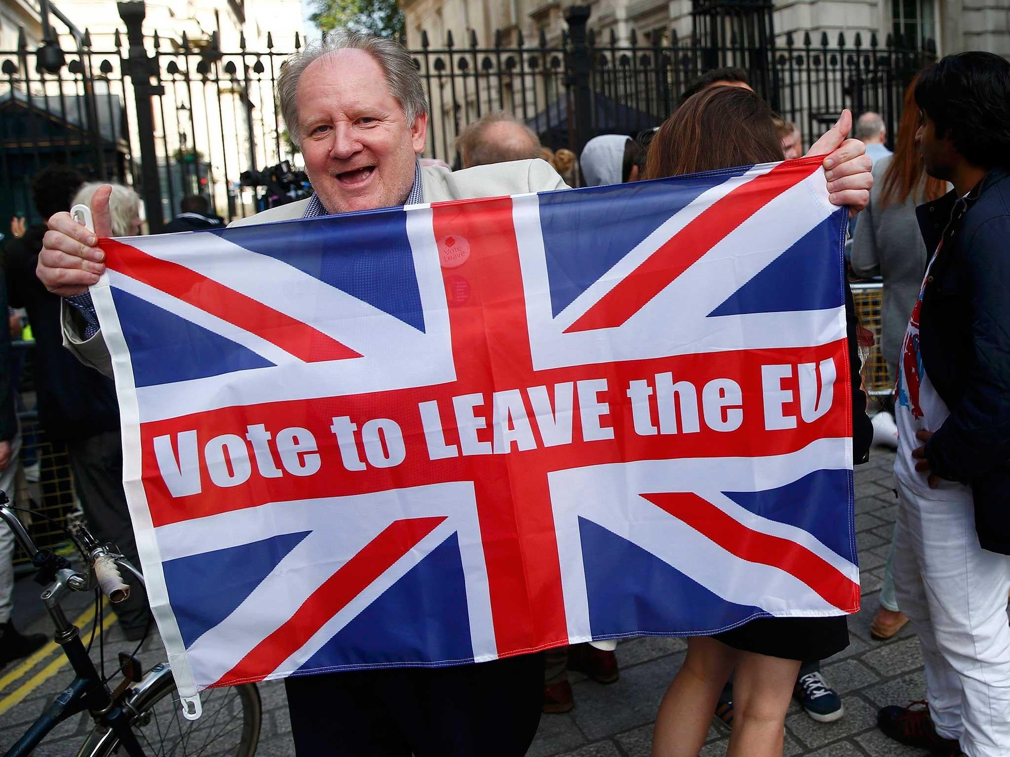 A vote leave supporter holds a Union flag, following the result of the EU referendum, outside Downing Street in London