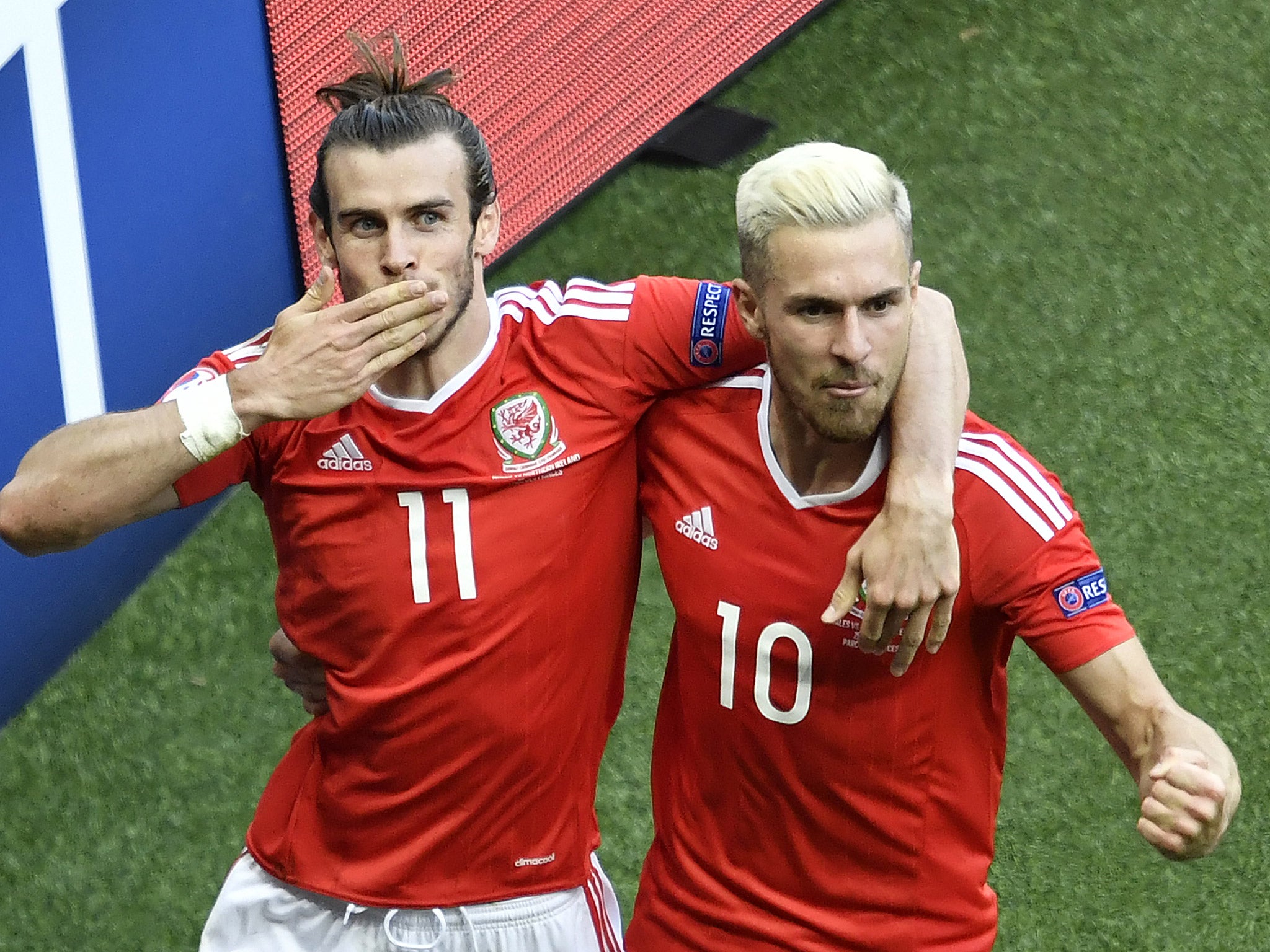 Bale and Ramsey celebrate after McAuley's own goal gives Wales the lead