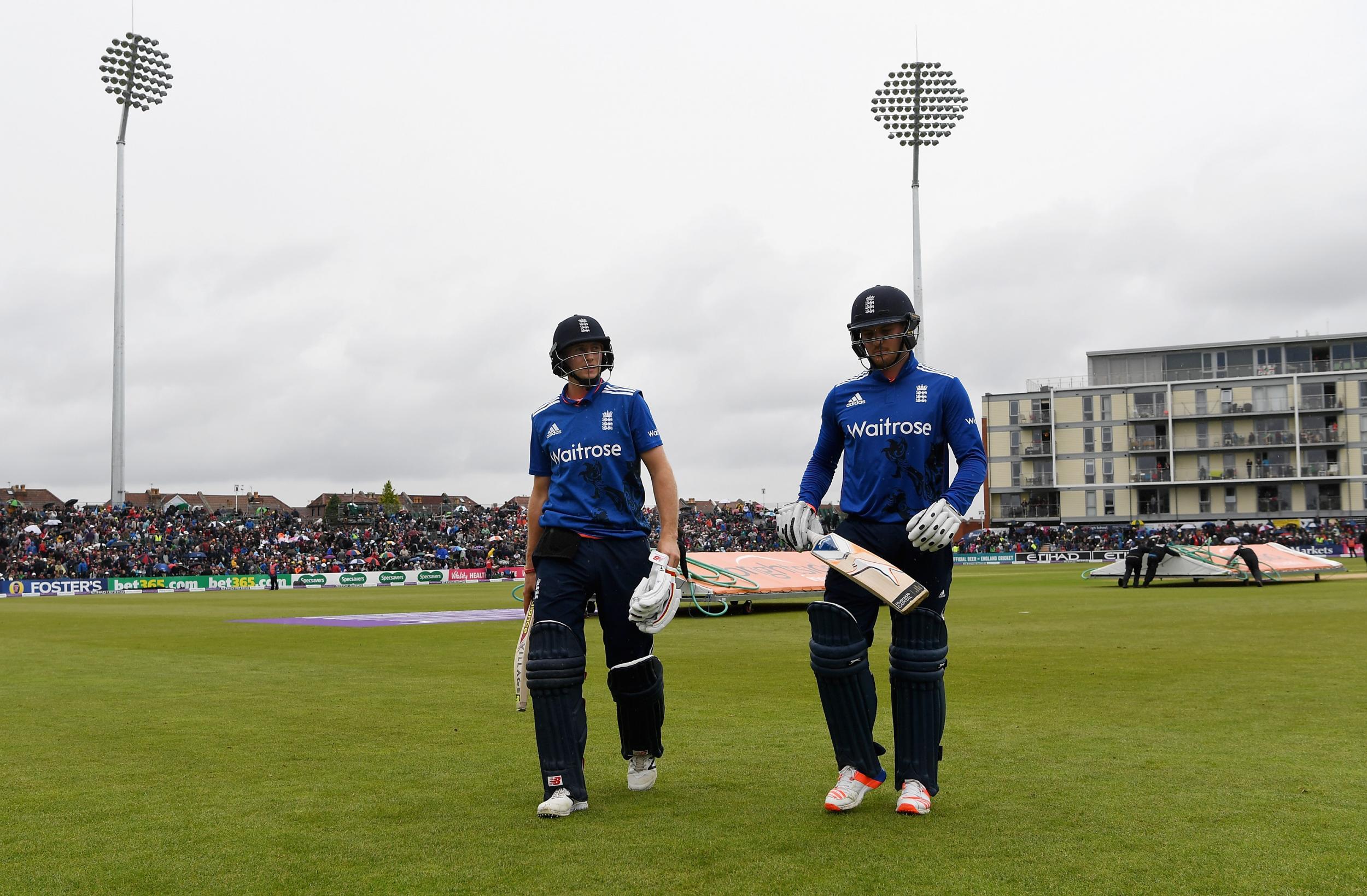 England's players leave the pitch after rain brought play to a halt