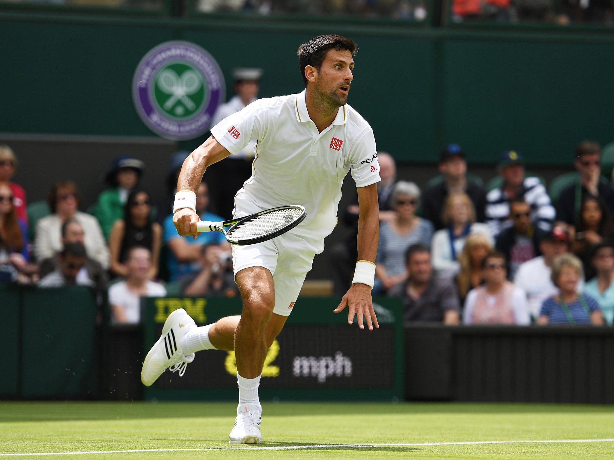 Novak Djokovic sprints forward to return a shot from James Ward