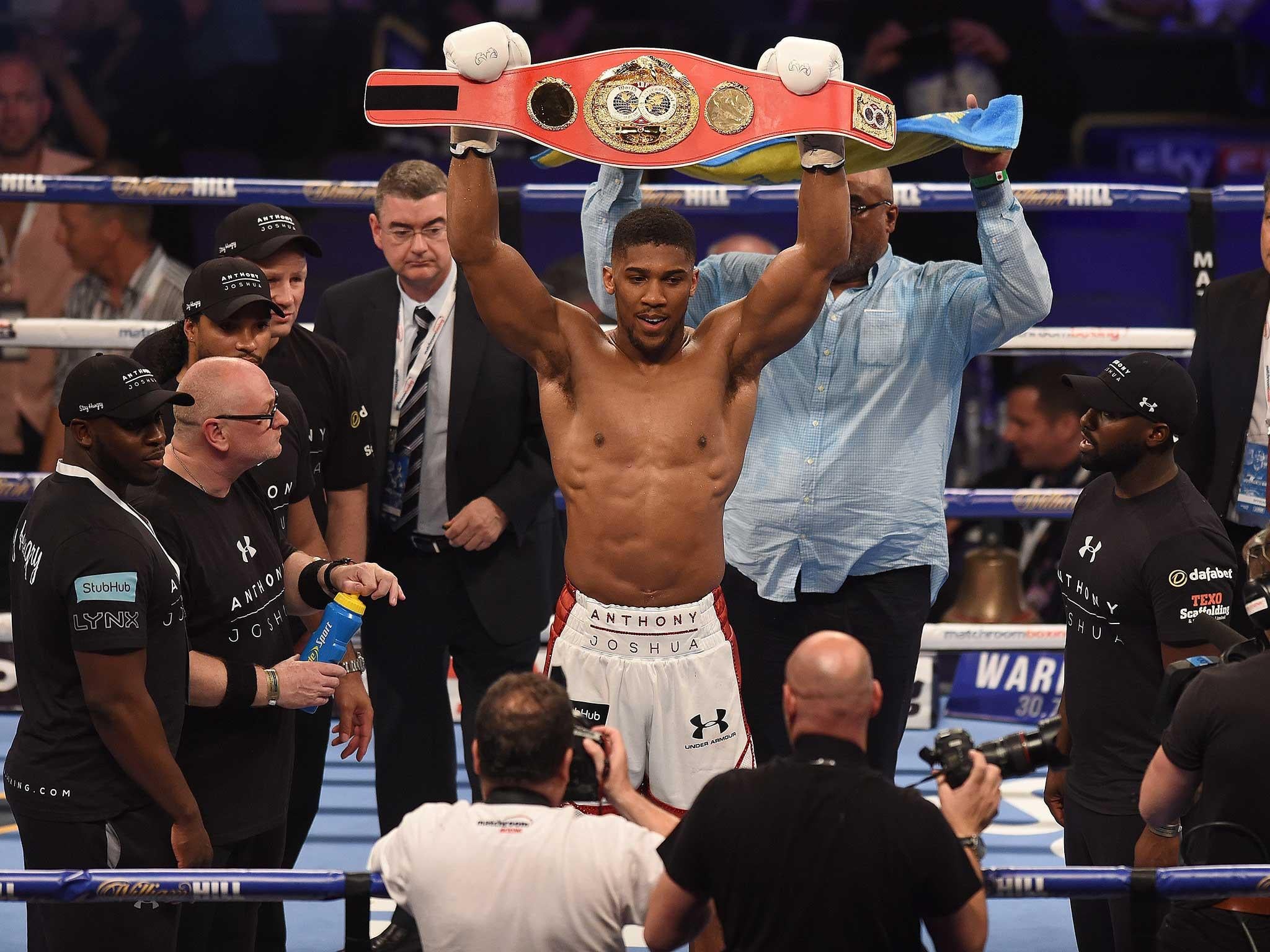 Anthony Joshua celebrates defeating Dominic Breazeale to retain the IBF World Heavyweight Title