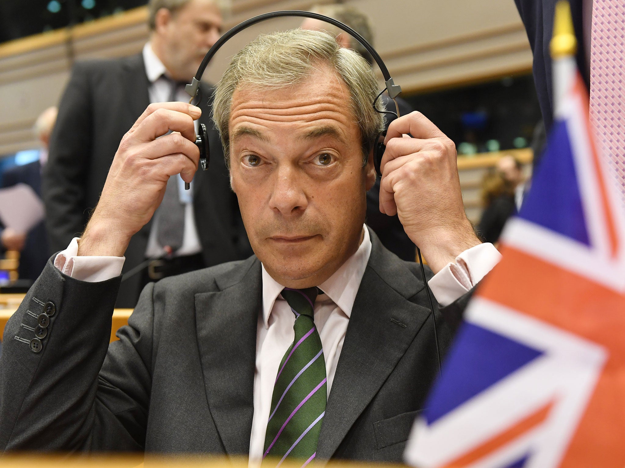 Nigel Farage sits behind a British flag during a special session of European Parliament in Brussels on Tuesday, June 28, 2016