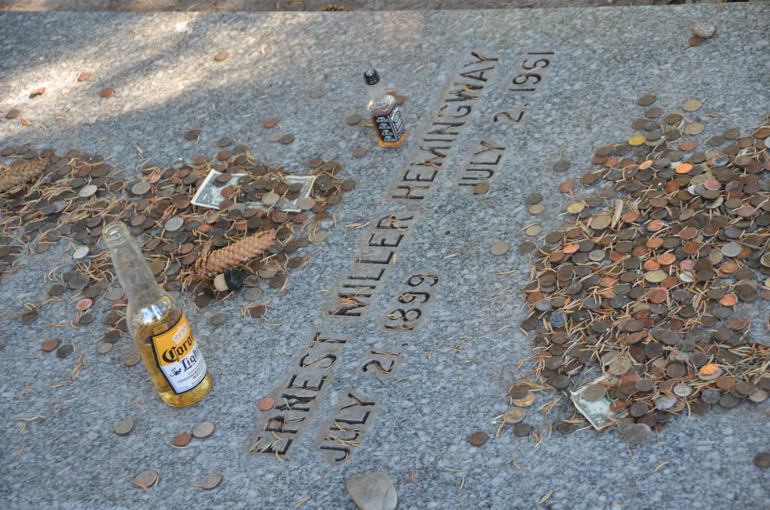 Visitors pay tribute to the writer with coins and drinks