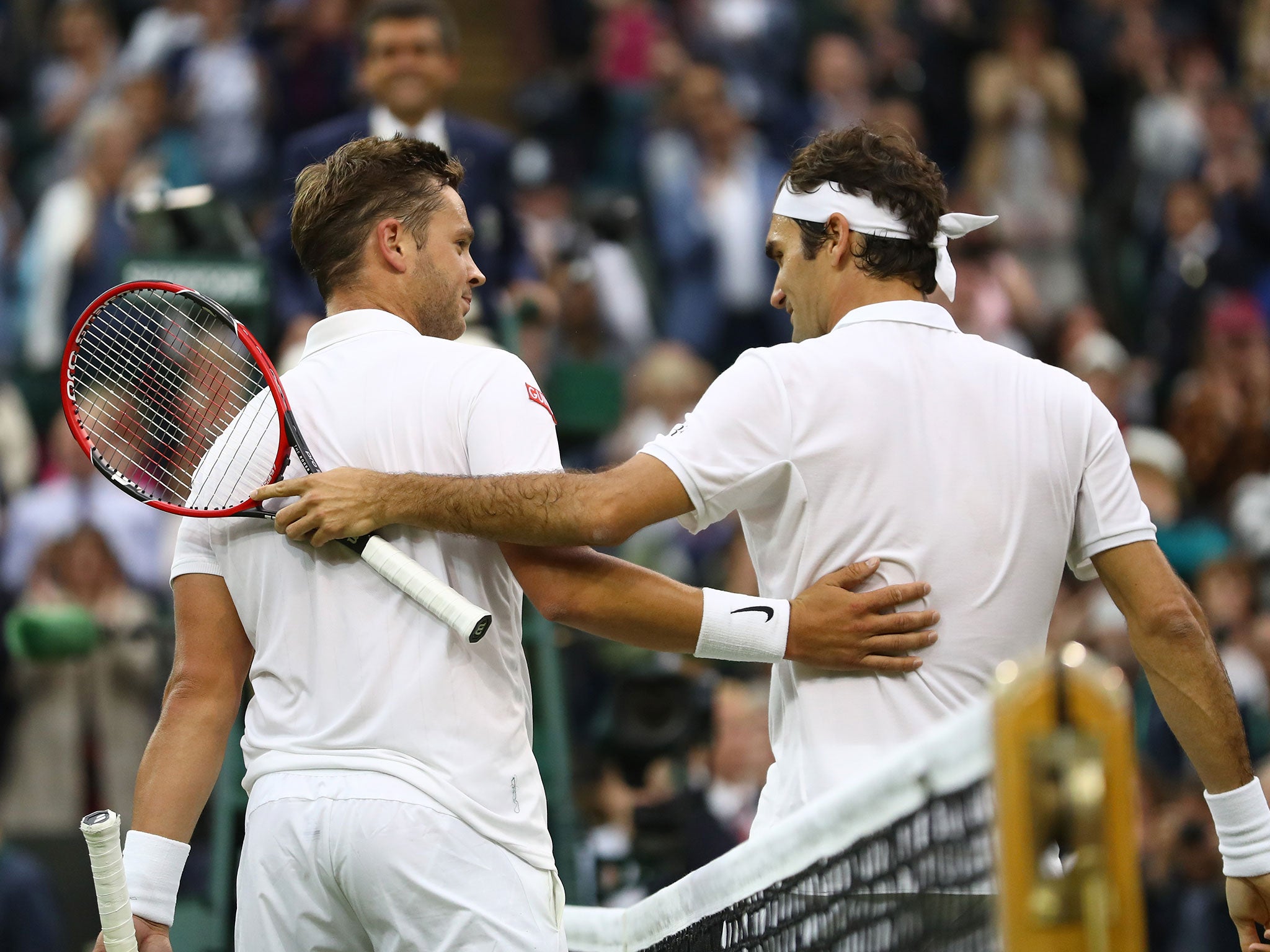 Marcus Willis and Roger Federer exchange words at the end of the Centre Court match