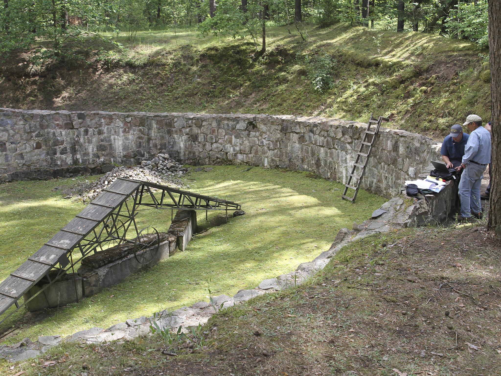 Geophysicists work at a pit used to hold victims before their execution at the Ponar massacre site near the town of Vilnius, Lithuania