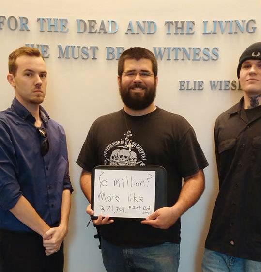 Matthew Heimbach (centre) at the Holocaust Memorial Museum in Washington DC, holding a handmade sign that reads 'Six million? More like 271,301'