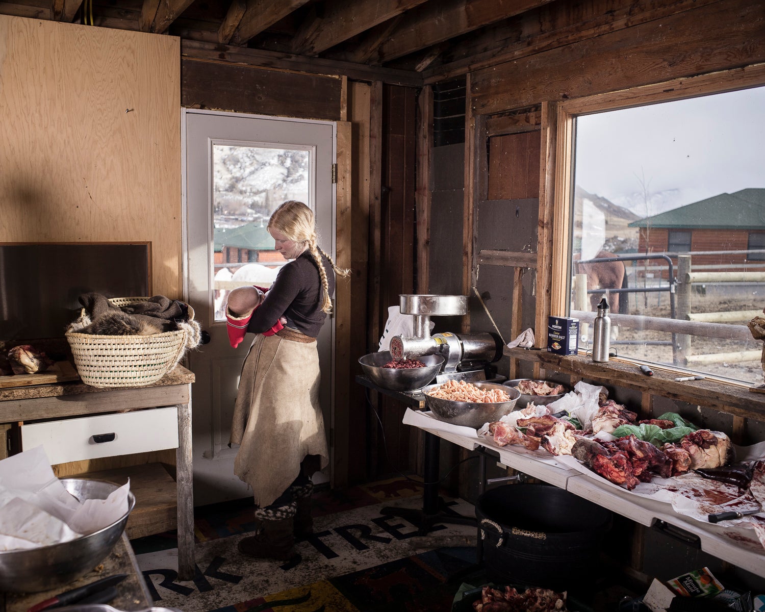 Epona nurses her son in the meat processing shed