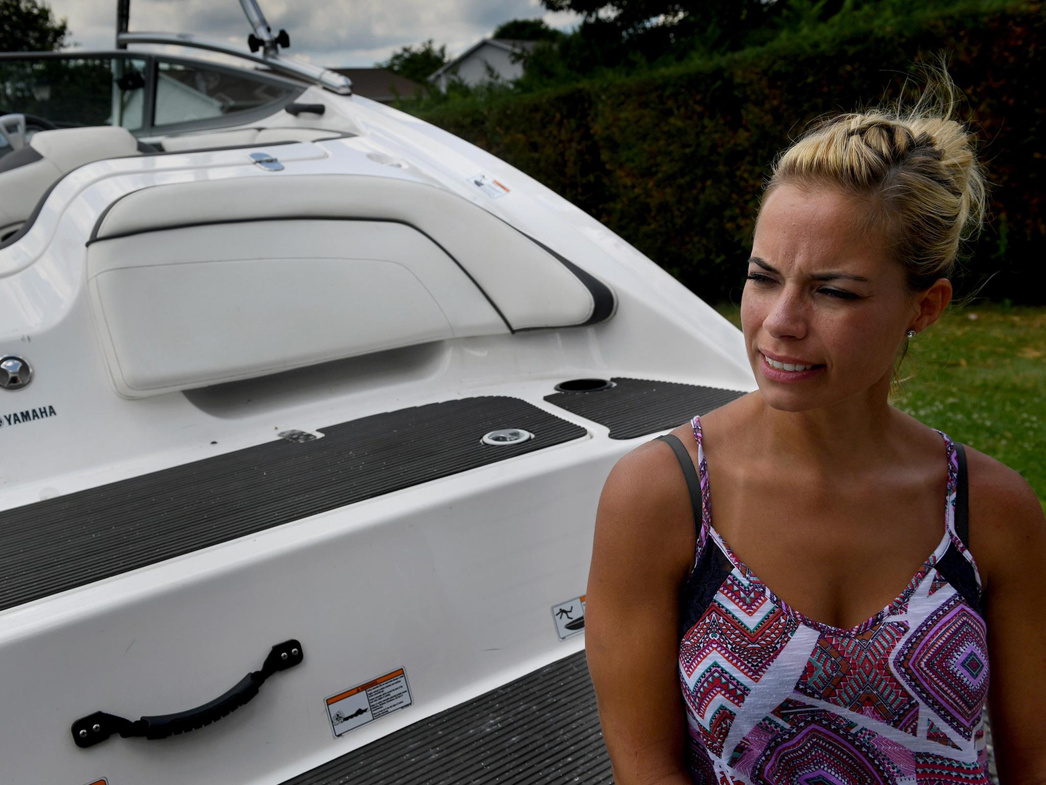 Lauren Conner with the boat she fell off of. She credits the fact that she's been a swimming fan since she was a child to her survival.