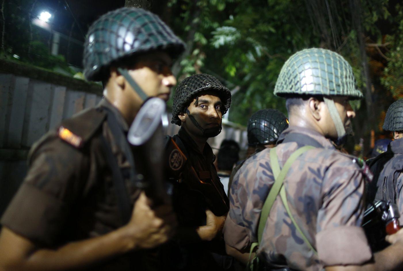 Bangladeshi security personnel stand guard near the restaurant after it was attacked by gunmen in Dhaka, Bangladesh, Friday, 1 July, 2016