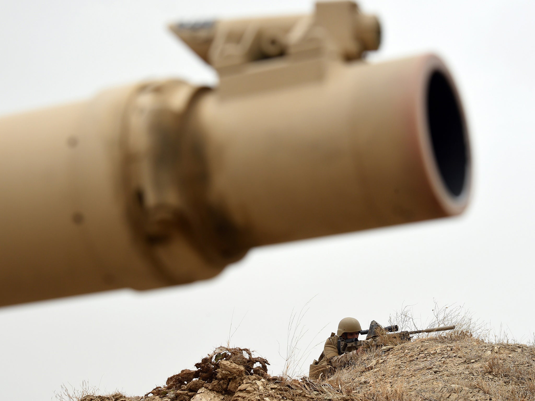 A Saudi army sniper takes position at look-out point in al-Dokhan mountain on the Saudi-Yemeni border in April - the UK has sold billions of pounds worth of arms to the Kingdom