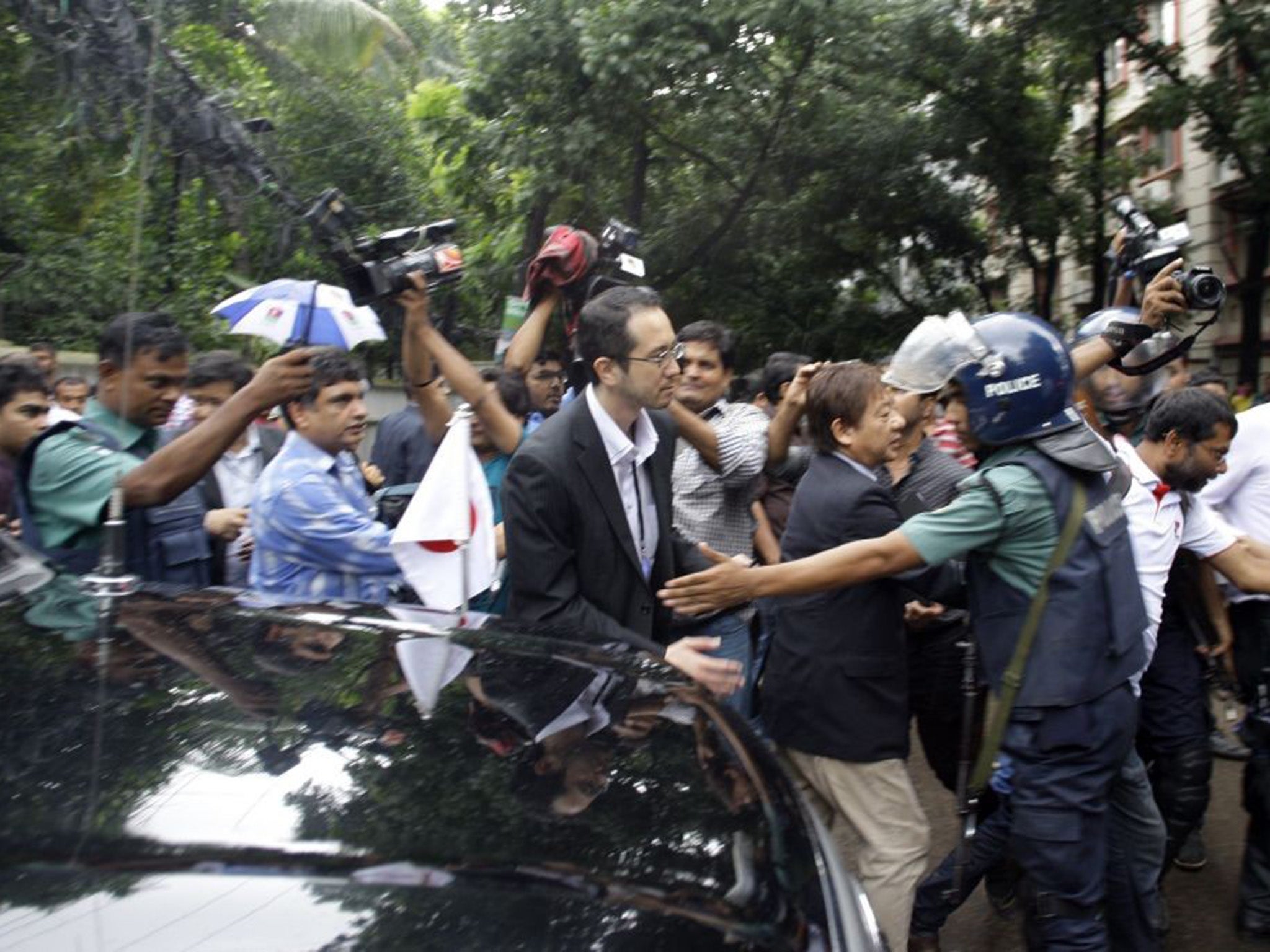 &#13;
Members of the Japanese Embassy arrive to pay their respects. Seven Japanese citizens were killed in the attack &#13;