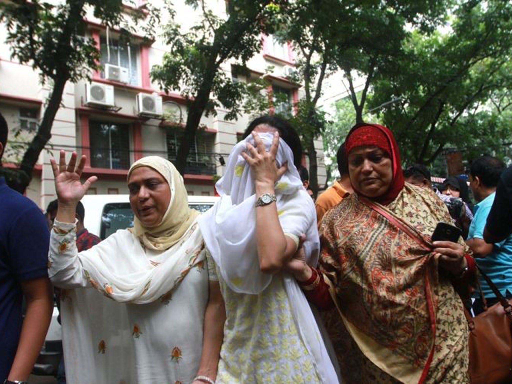 &#13;
Relatives of the Dhaka attack victims arrive at the Holey Artisan Bakery cafe to identify their loved ones &#13;