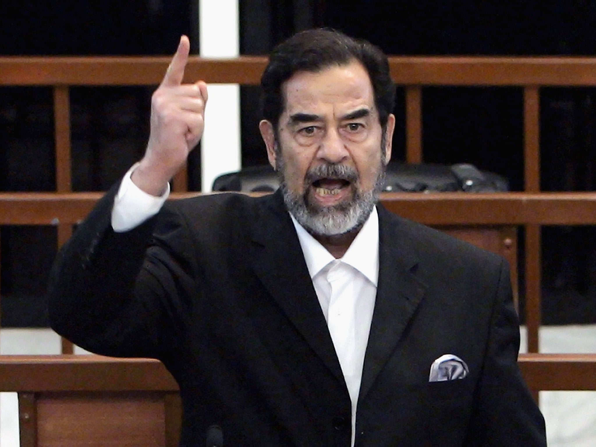 Former Iraqi President Saddam Hussein shouts as he receives his guilty verdict during his trial in the fortified 'green zone', on November 5, 2006 (Getty)